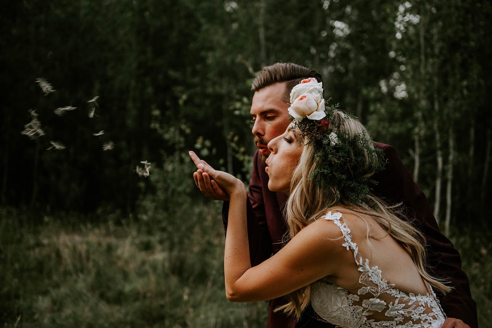 Bride and groom making a wish on a dandelion together at shevlin park 