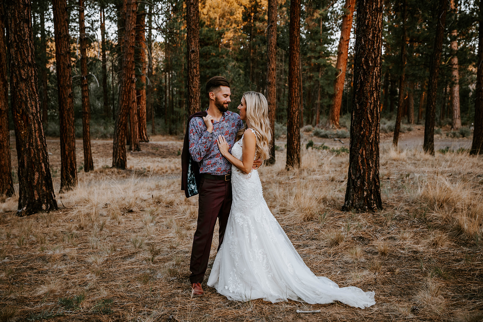 Bride and groom standing together in the ponderosa pines at shevlin park  