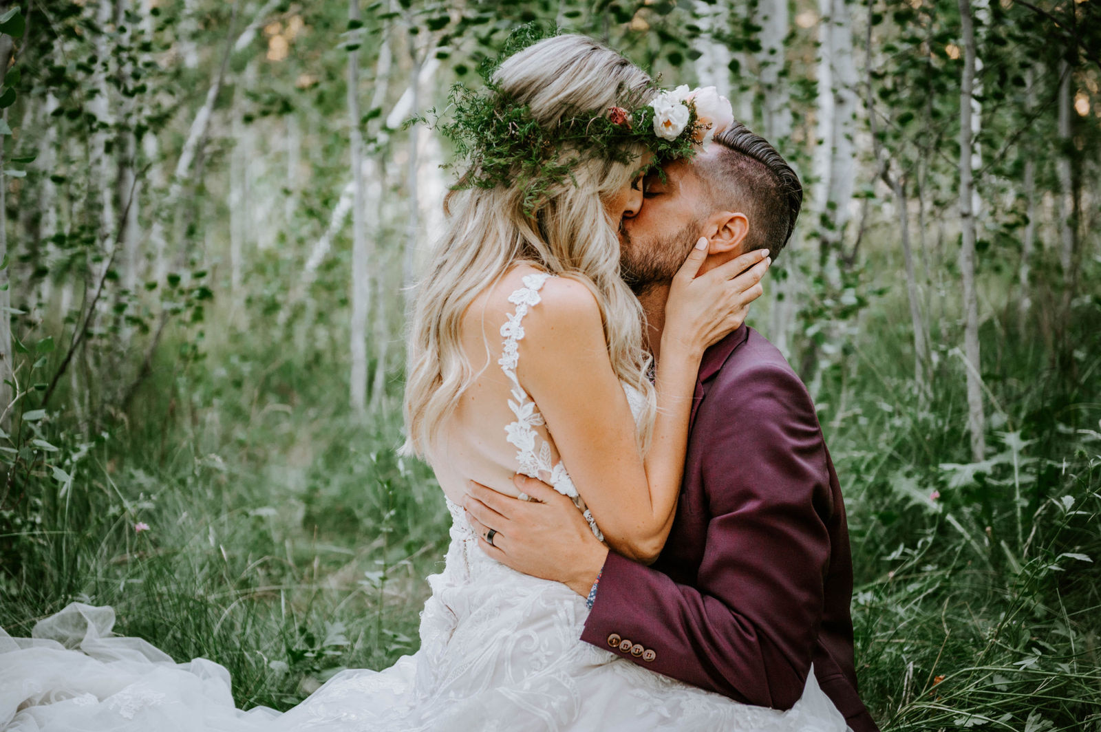 Bride straddling and kissing the groom in a grove of aspen trees at shevlin park, across from aspen hall