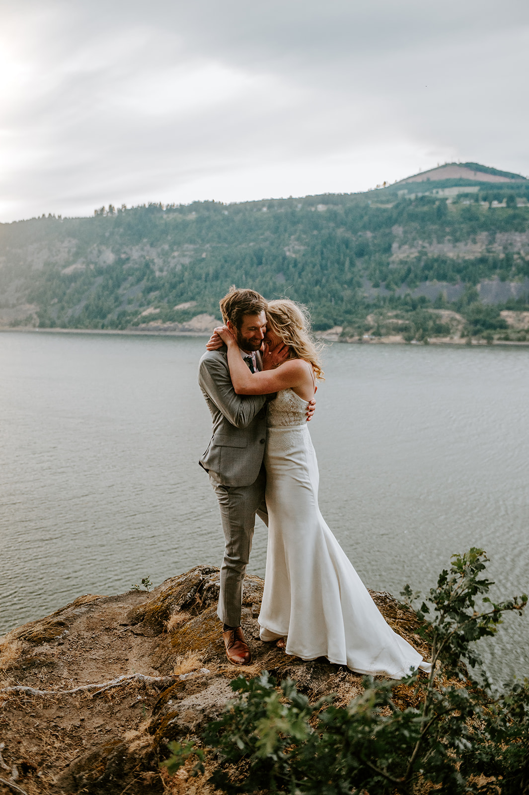 Bride and groom embracing on the overlook at Westcliff Lodge in Hood River