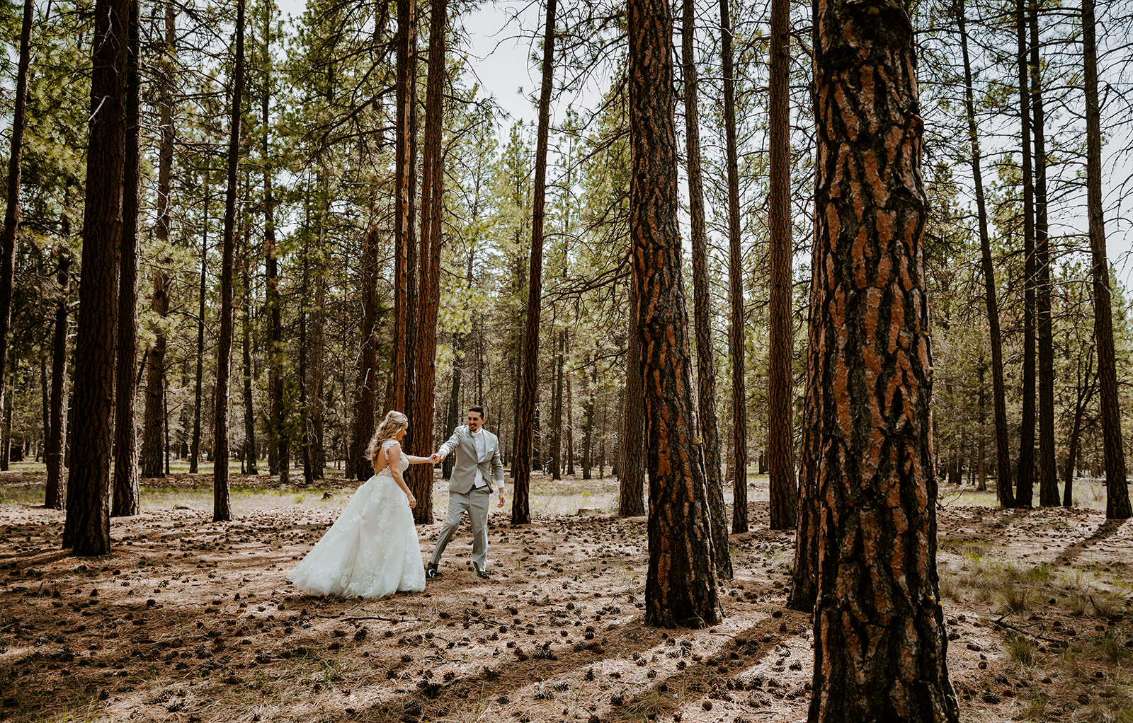 Bride and groom dancing in the ponderosa pines at five pine lodge