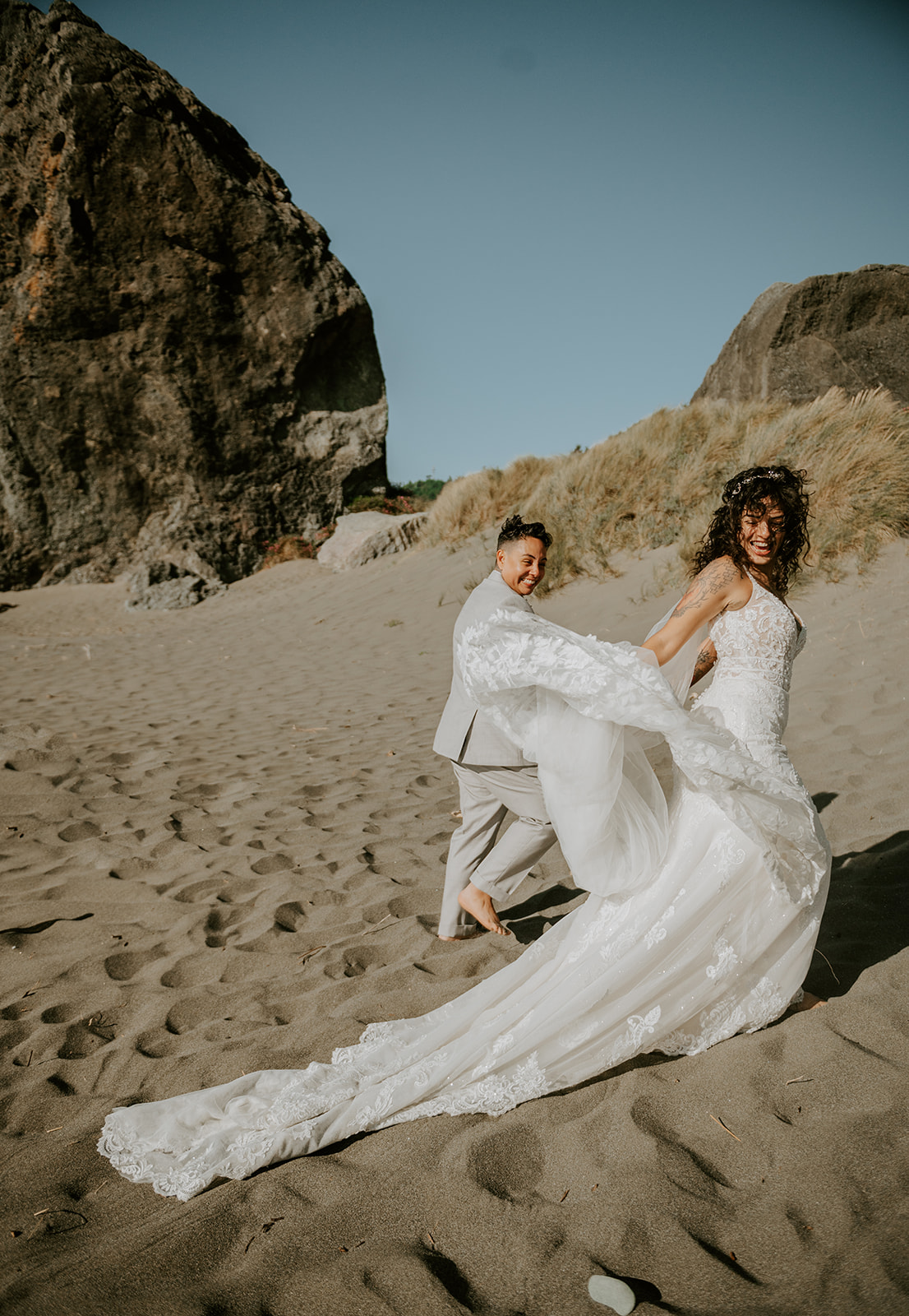 Two brides after their wedding ceremony at kissing rock on the Oregon coast