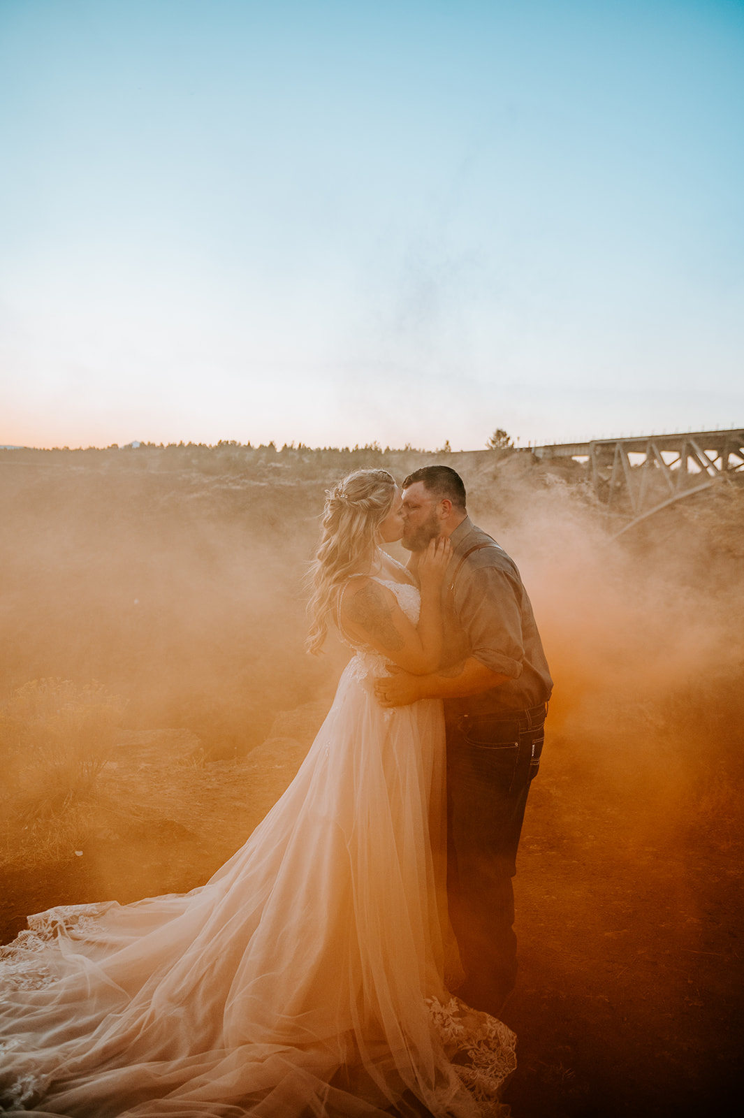 Bride and groom at Peter Ogden state park with orange smoke bomb