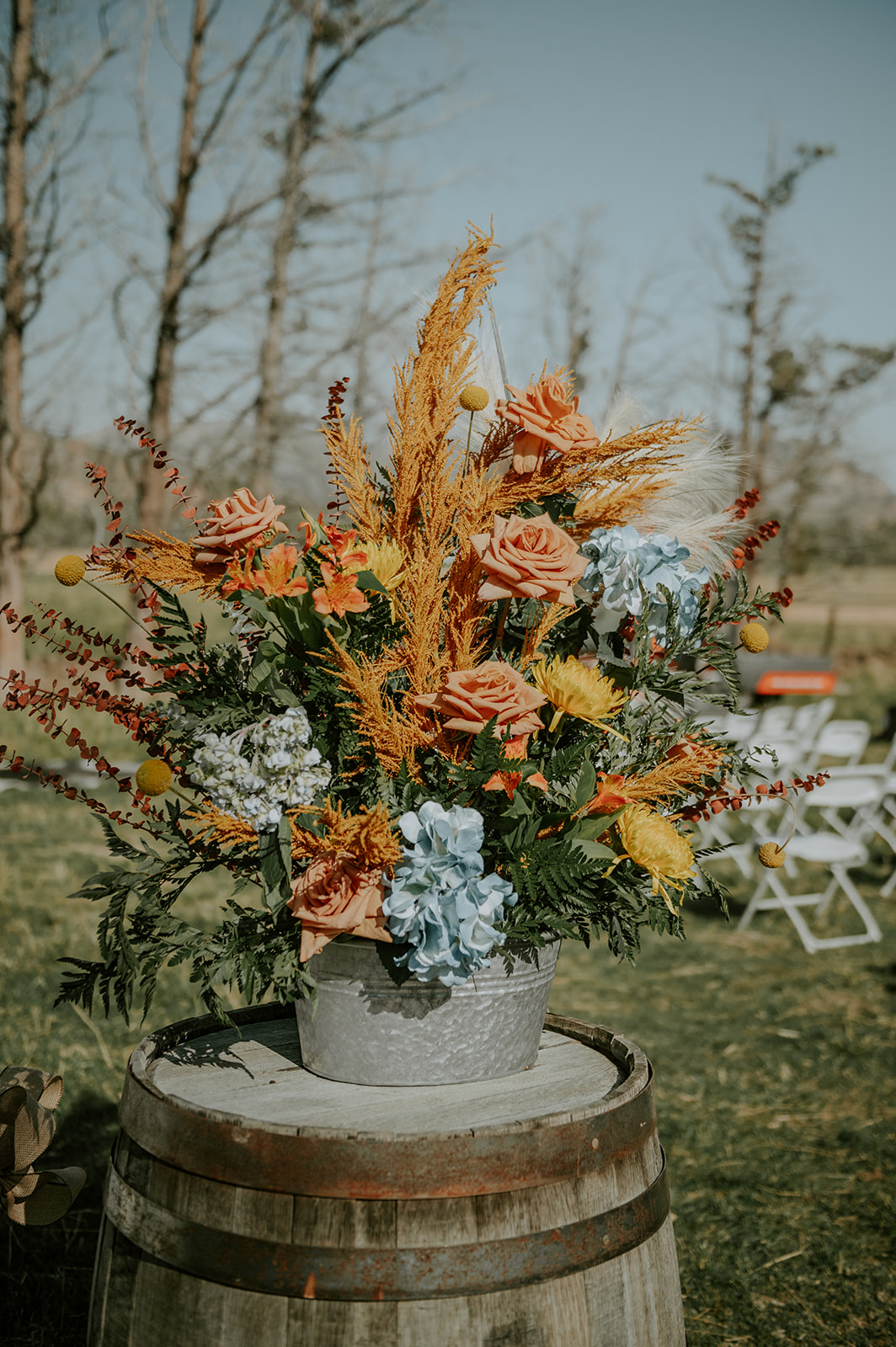 Country chic wedding flowers on top of a wine barrel  