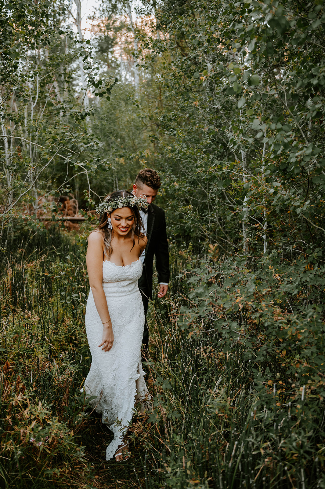 Bride leading groom through the aspen trees at shevlin park