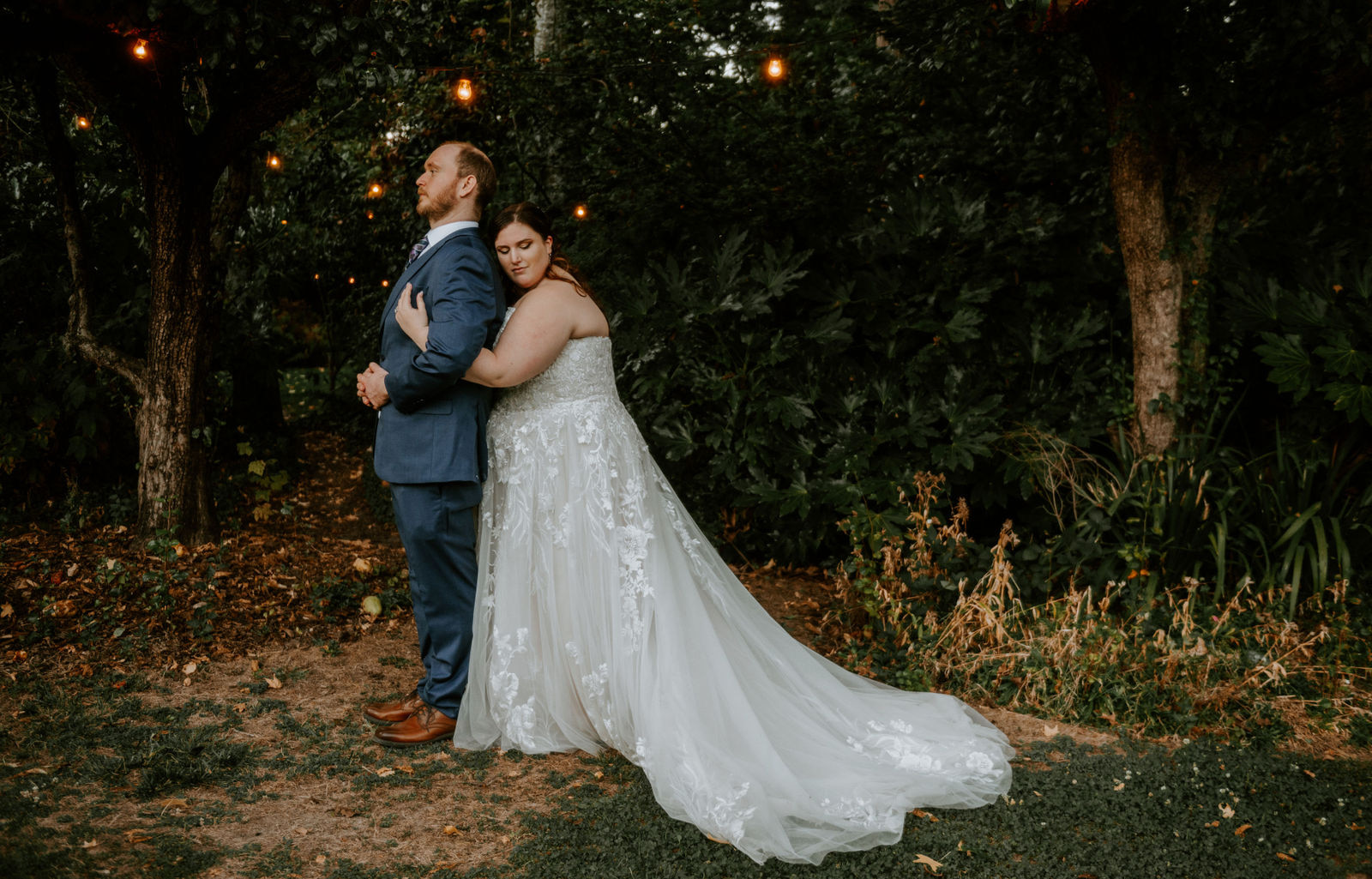 A bride hugging a groom from behind in the gardens at the McMenamins Cornelius Pass Roadhouse