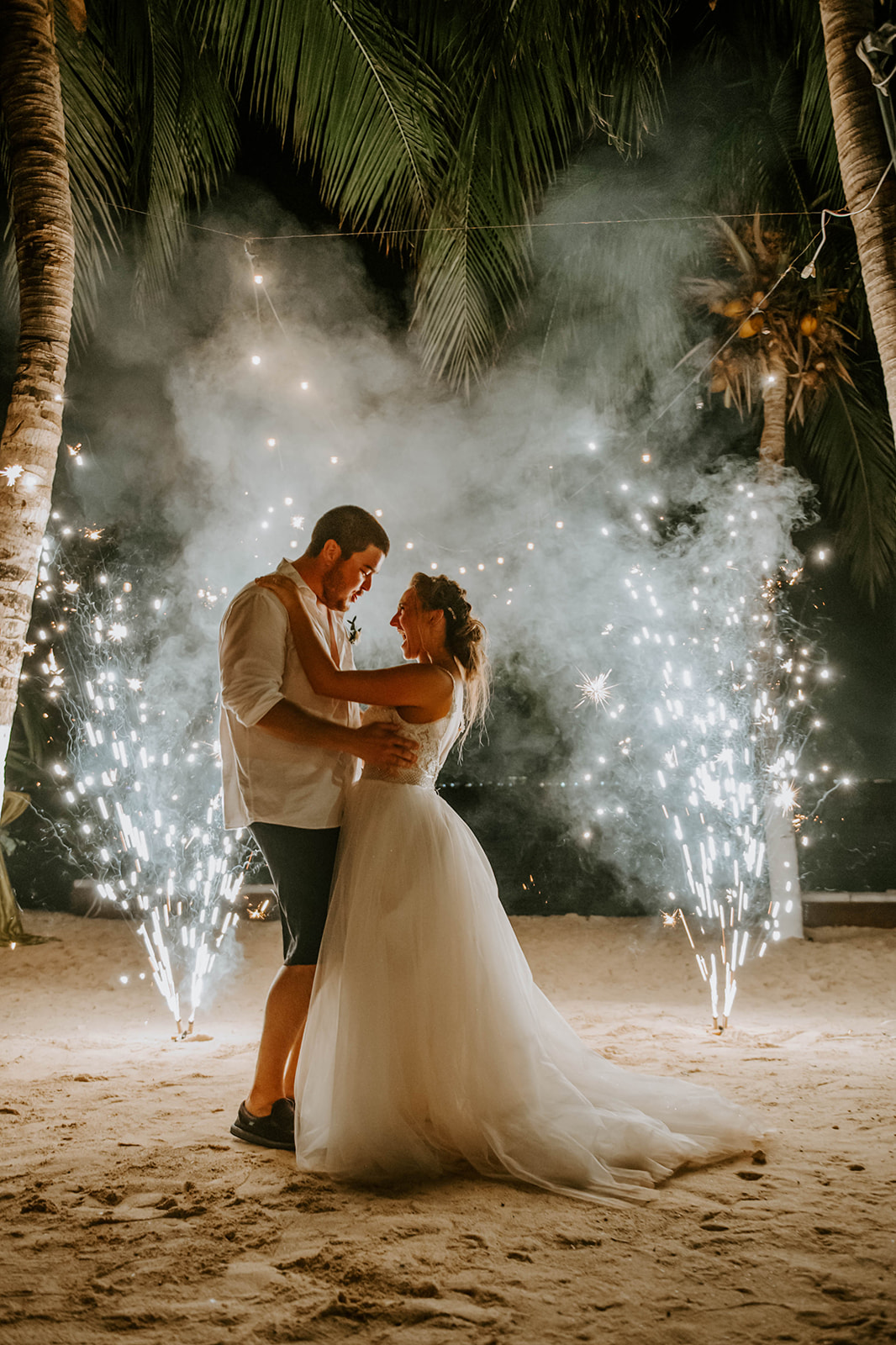 Bride and groom celebrating with fireworks at Zama wedding in Isla Mujeres