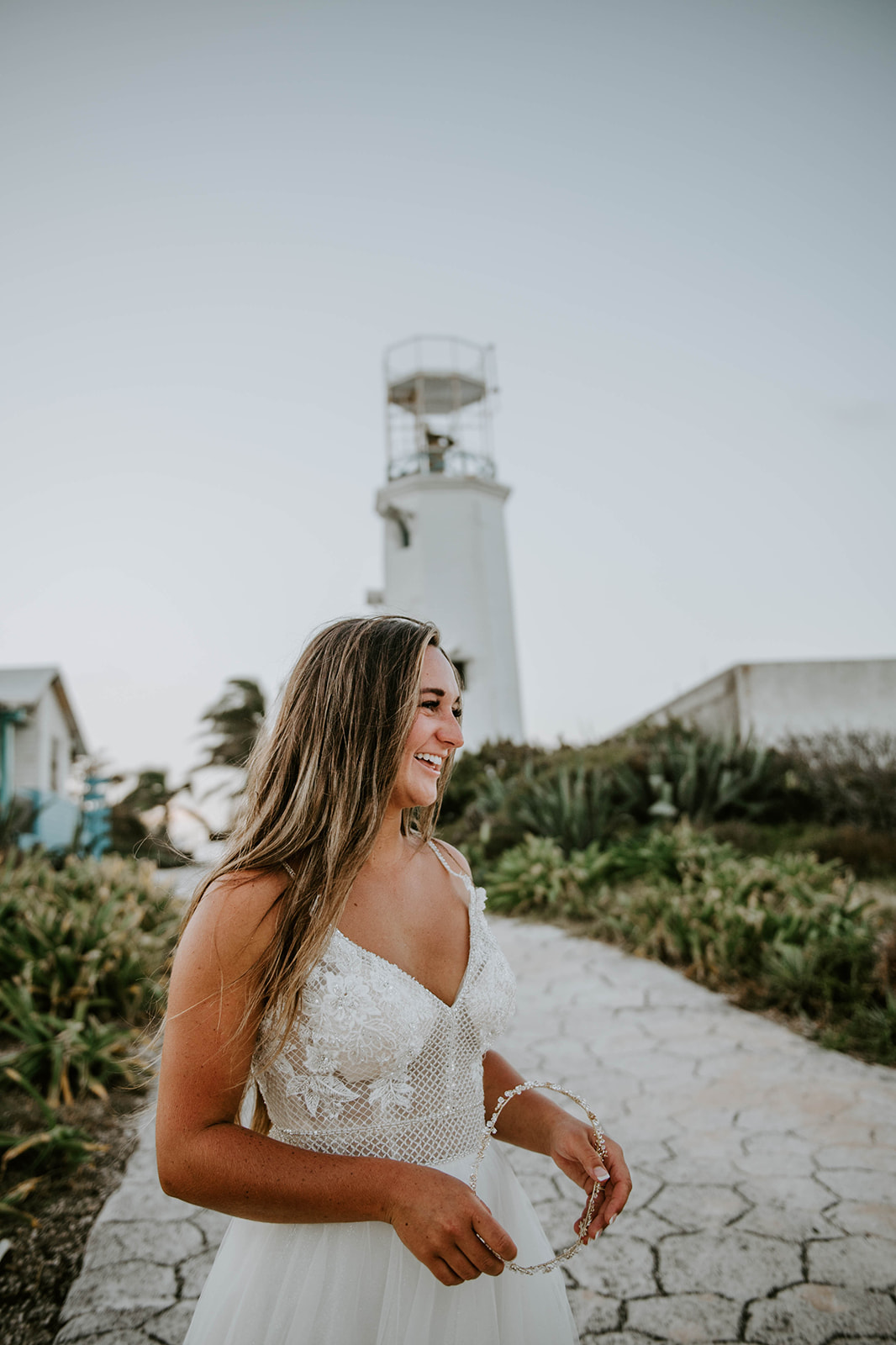 Bride smiling near a lighthouse 