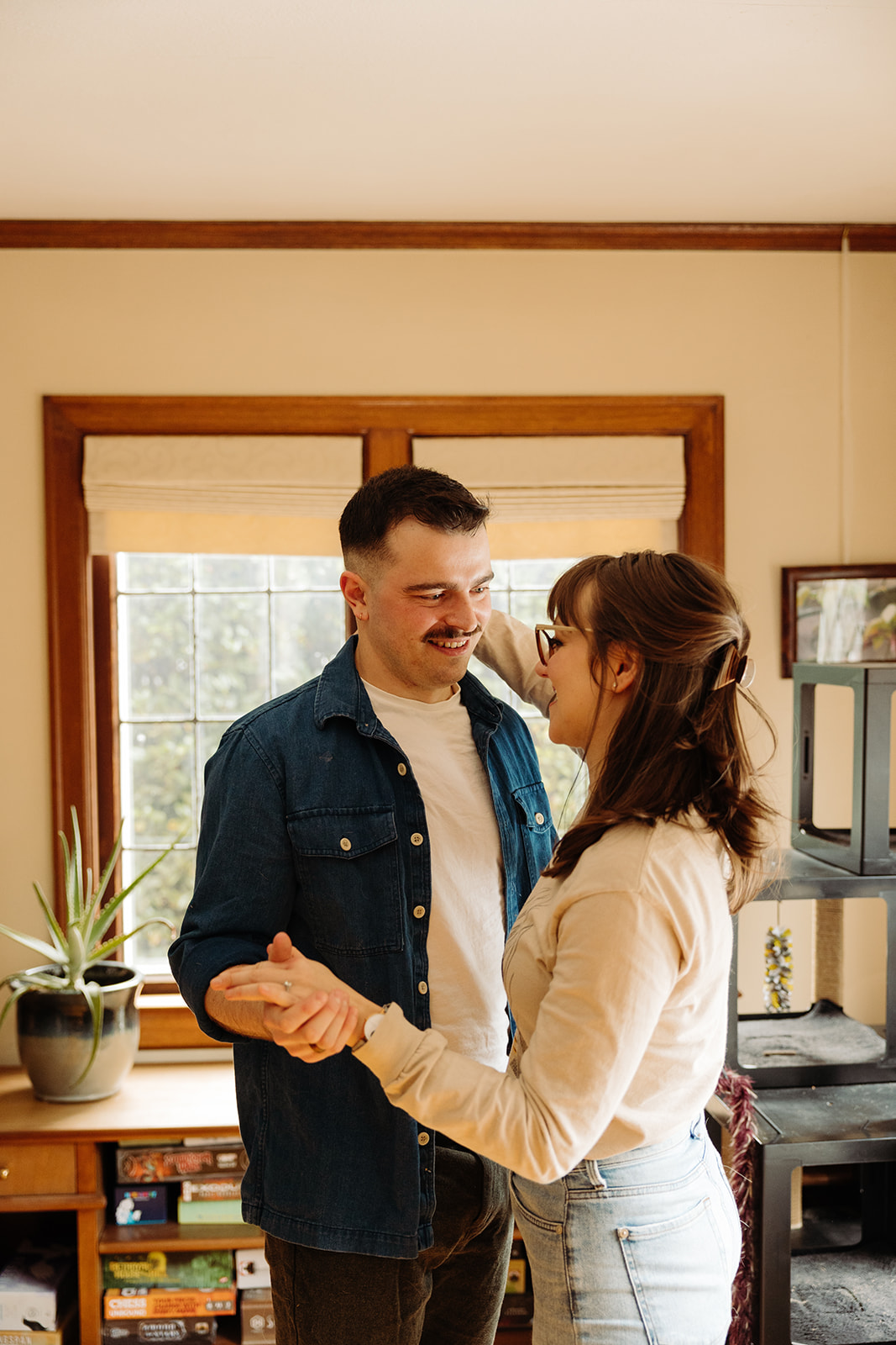 Couple practices their first dance during their at home engagement photo session