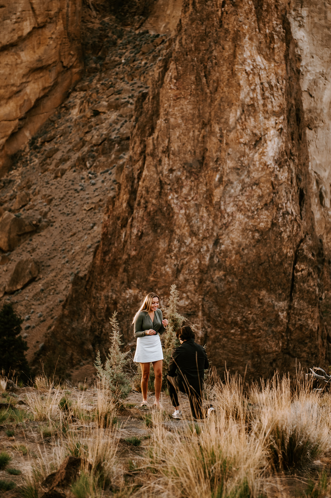 Guy on his knee proposing to his girlfriend at smith rock