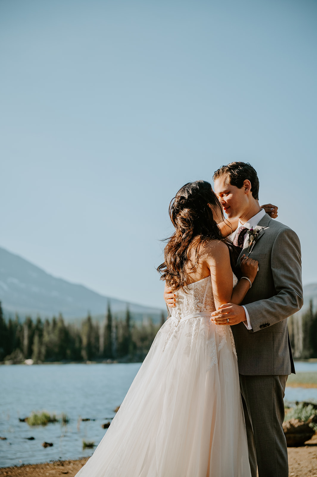 Bride and groom sharing their first kiss after eloping at sparks lake in bend 