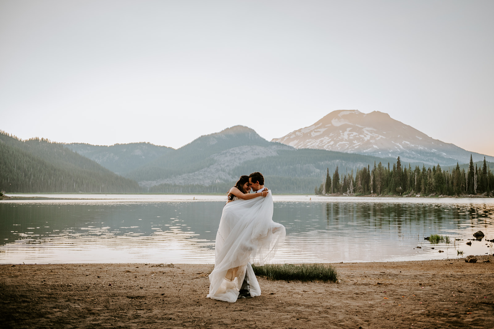 Groom holding bride at their elopement at sparks lake