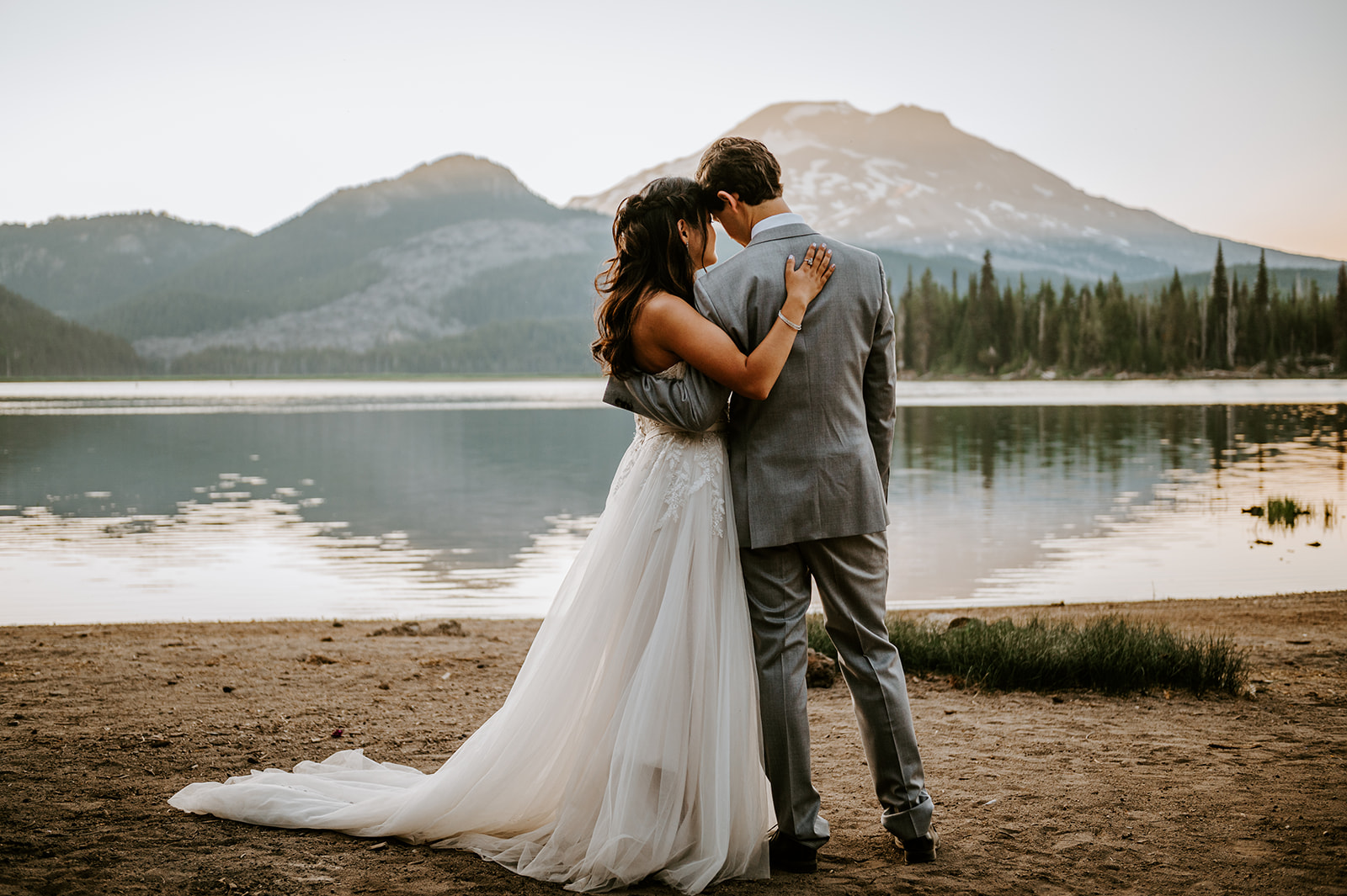 Newlyweds overlooking south sister together after eloping at sparks lake 
