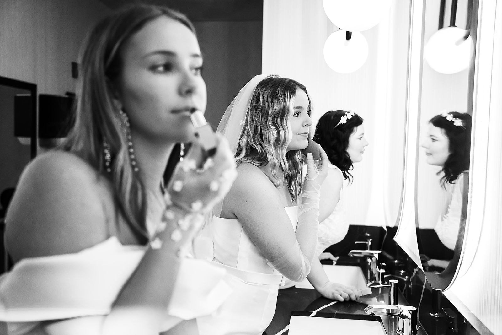 Three brides getting ready in dressing room at The Graduate Hotel, photography by LinenandElm.com