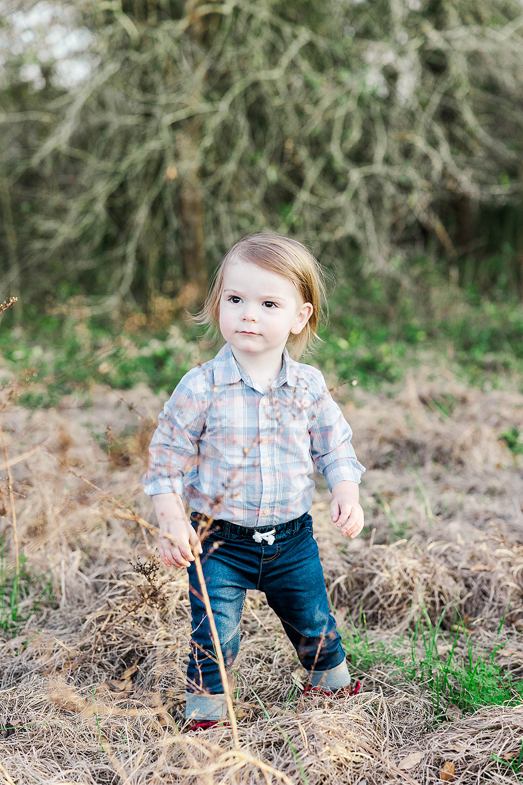 toddler boy in field