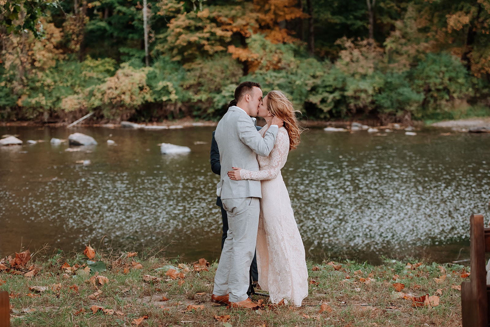 After their river front wedding ceremony, this hipster couple shares their first kiss.