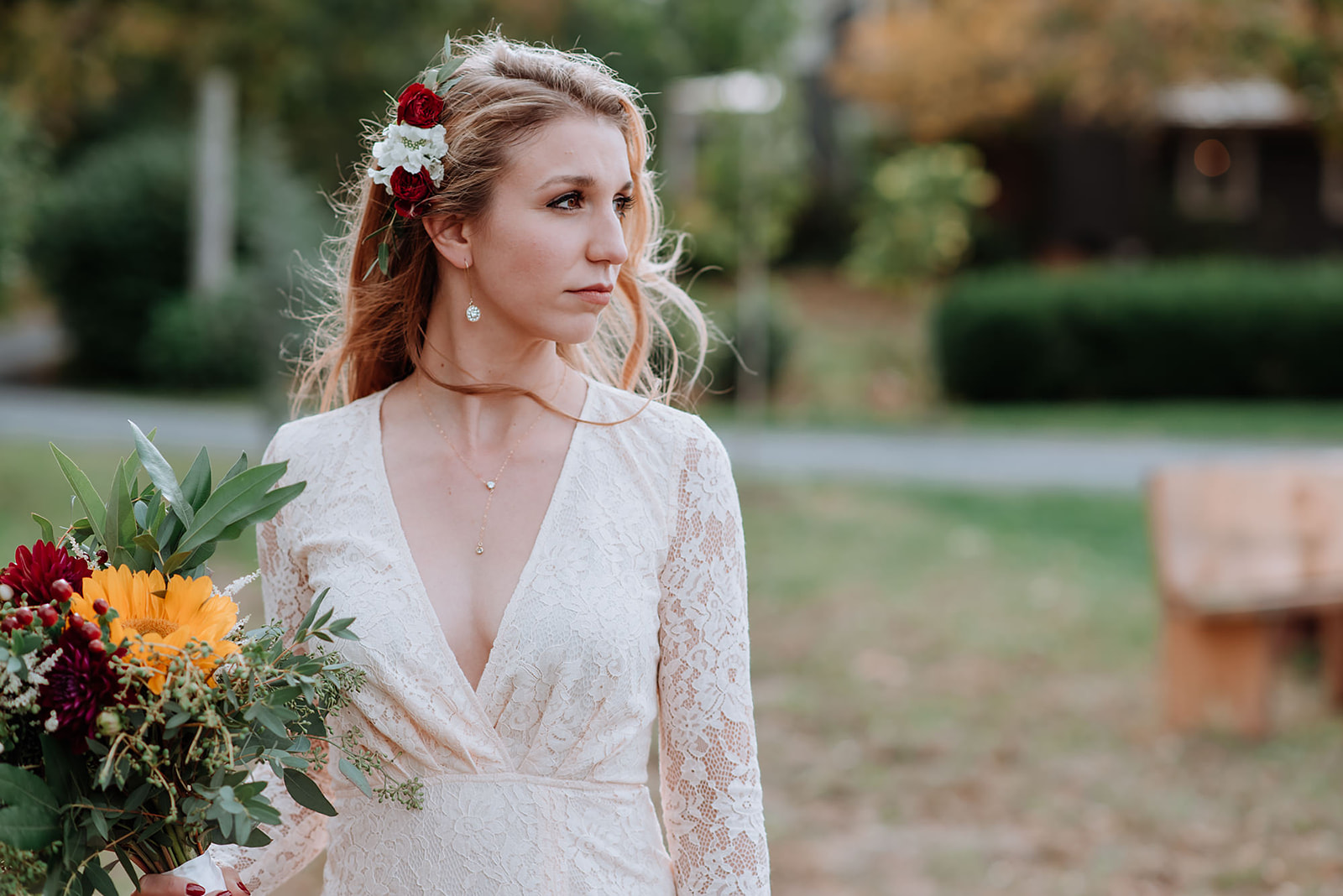 Bride wears a v-neck plunge neckline ivory lace vintage dress she thrifted from a Hudson Valley shop.