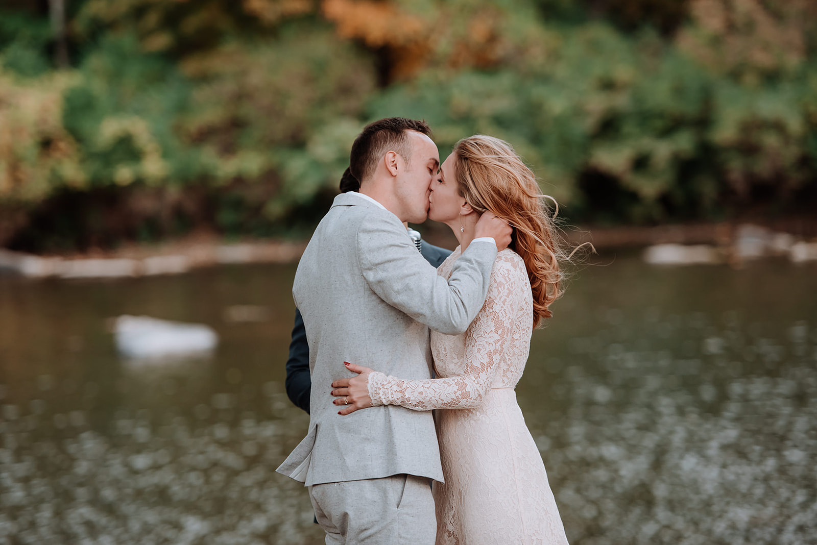 Couple embraces to share their first kiss after saying I Do.