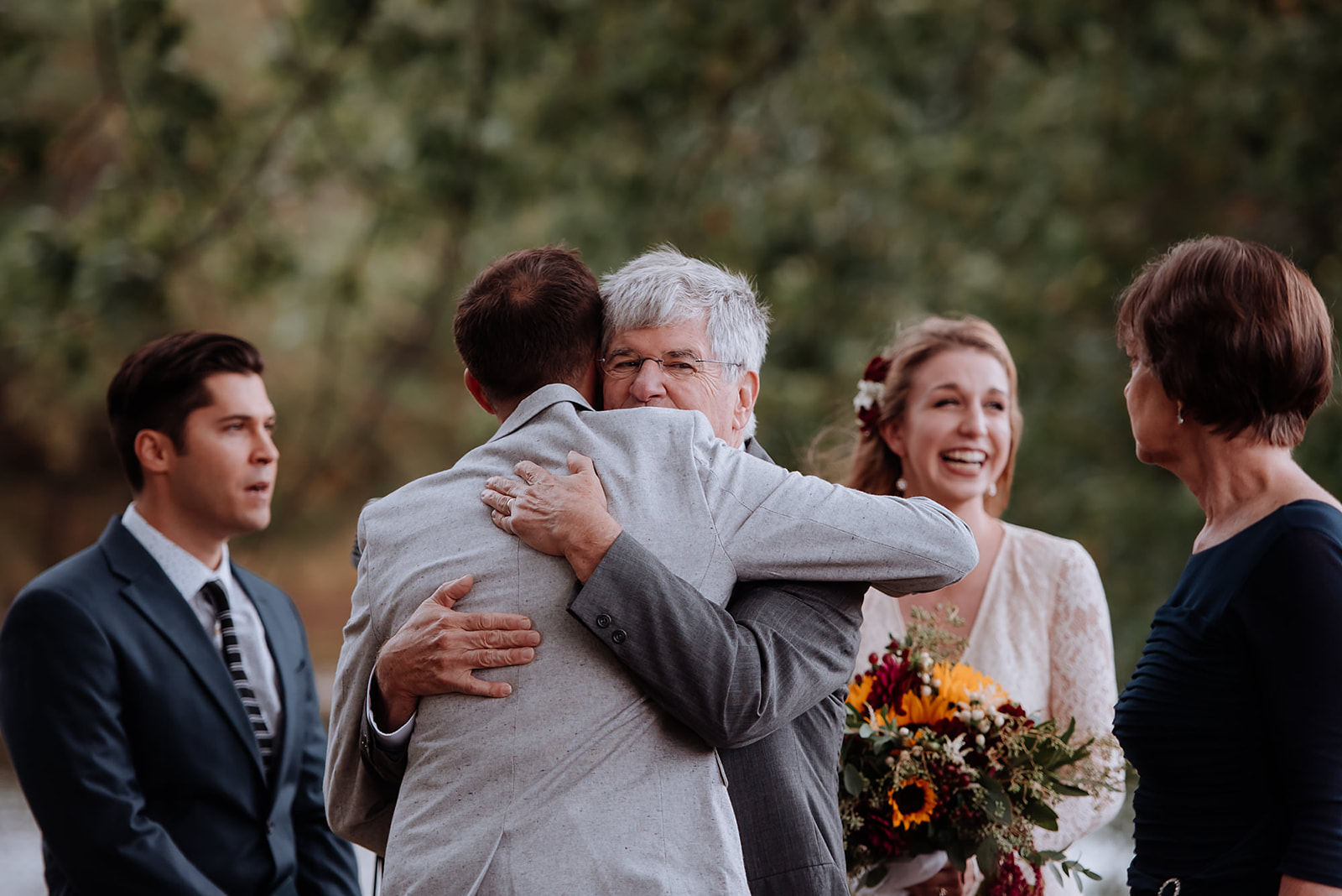 Groom hugs his Bride's Father at the end of the aisle to start their ceremony.