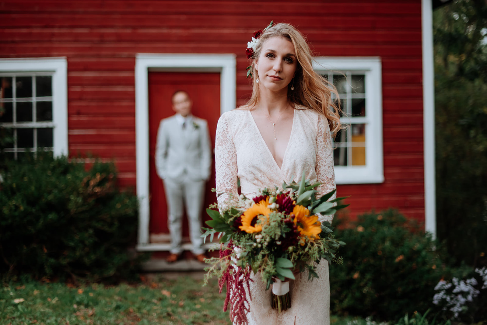 Romantic bridal portrait of vintage bride in front of red barn at Crested Hen Farms wedding, New York