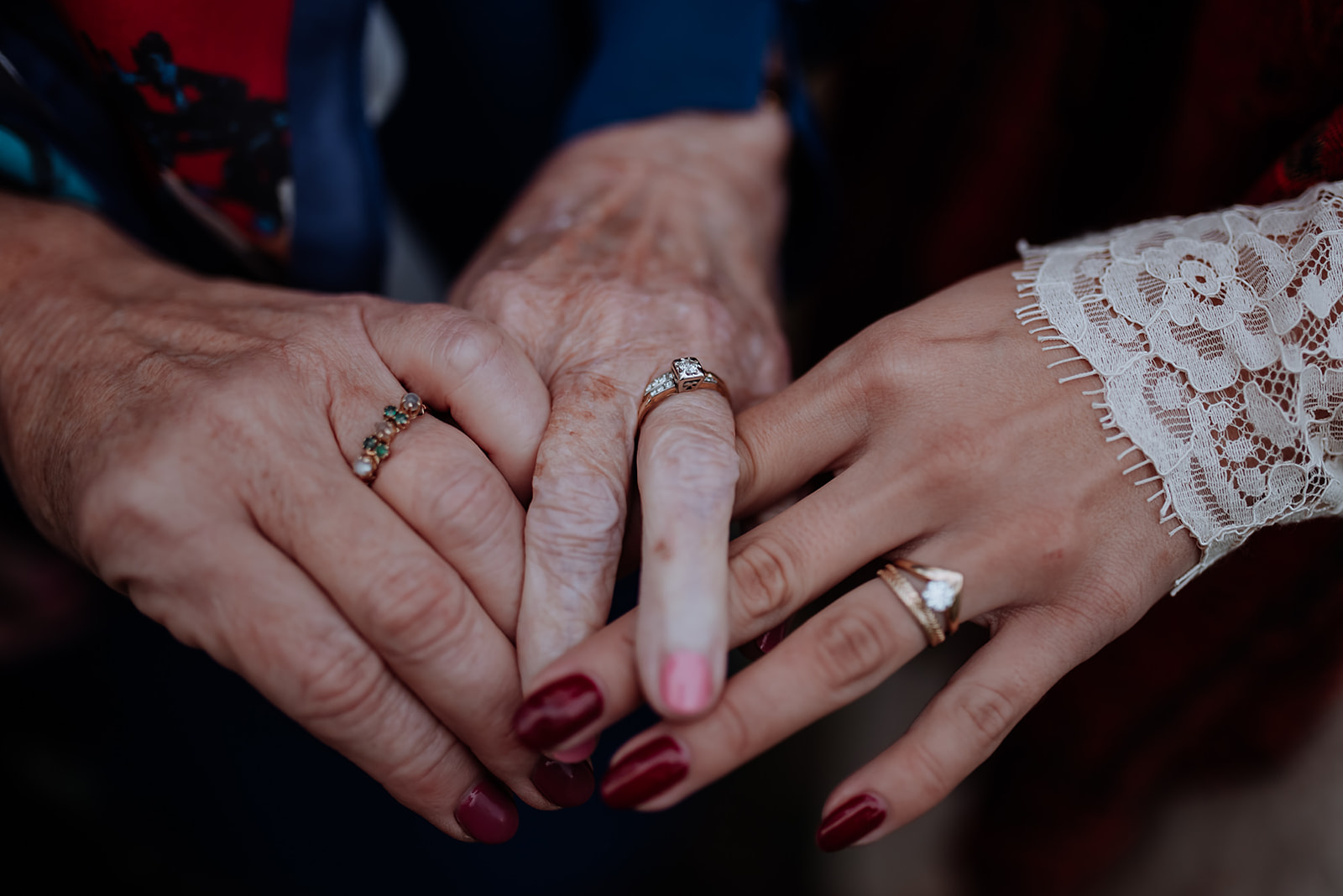 Three generations of women's hands with their antique wedding rings.