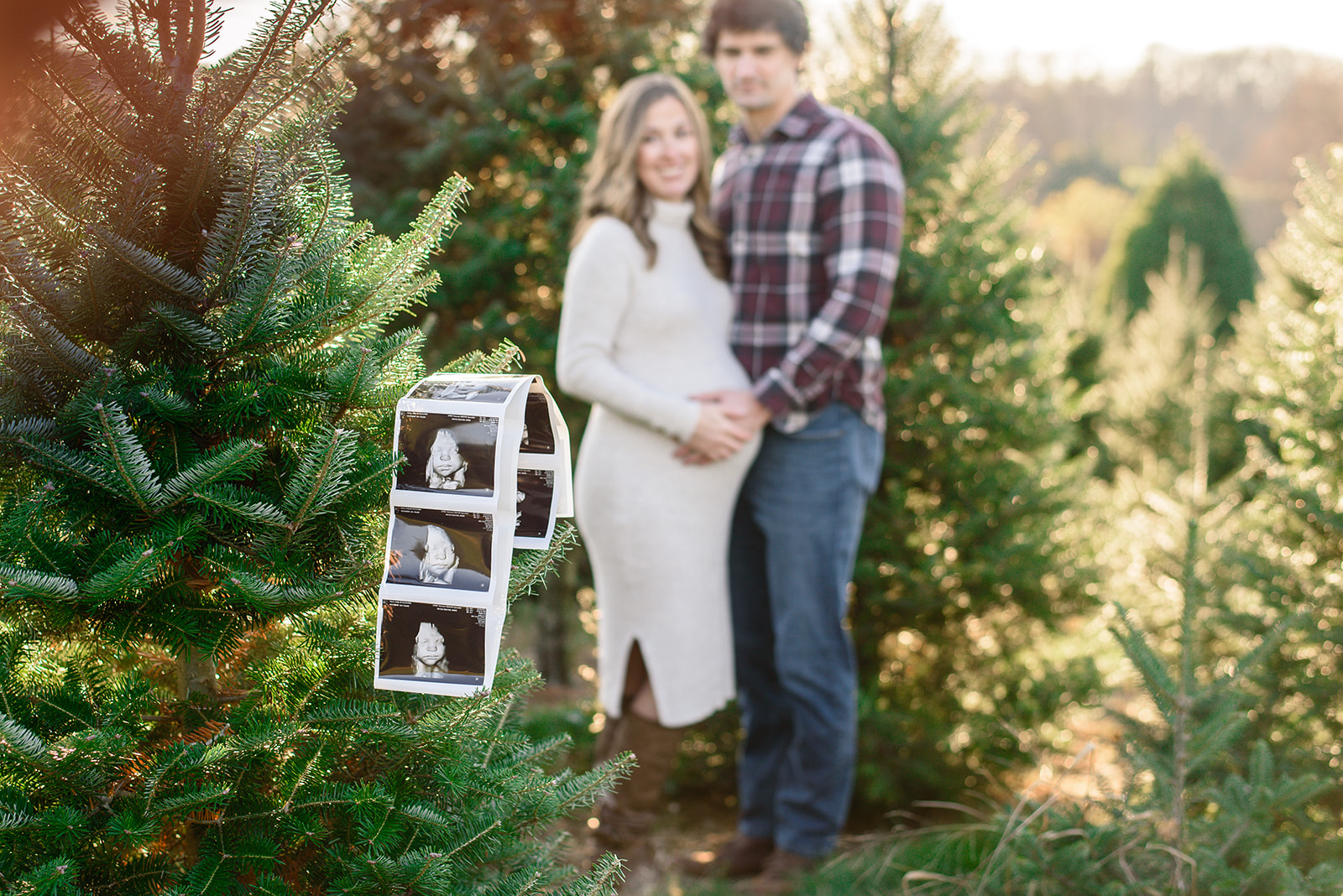 An ultrasound picture hangs on a Christmas tree during a maternity photoshoot with Rachel Mummert Photography