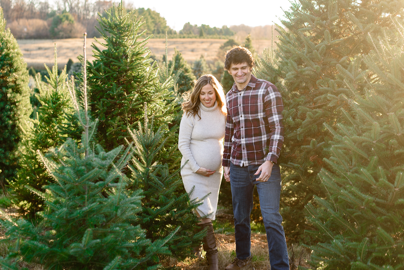 An expecting couple walks during their maternity session with Rachel Mummert Photography