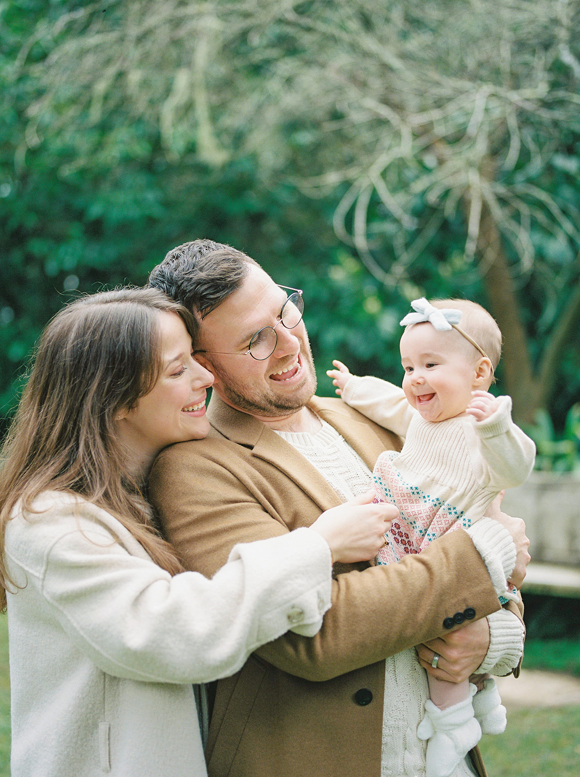 A family holding baby in San Francisco garden