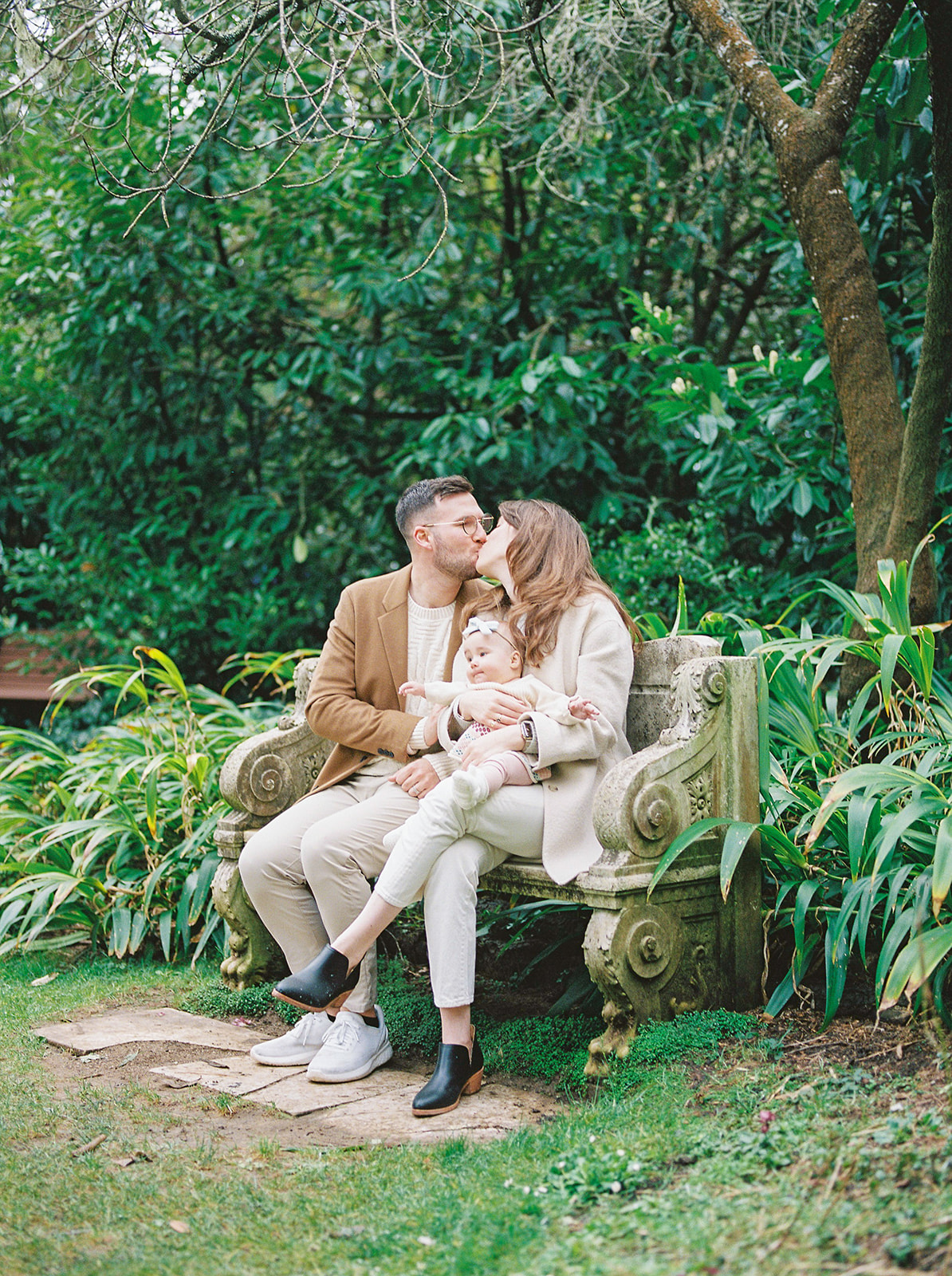A family holding baby in San Francisco garden photography session