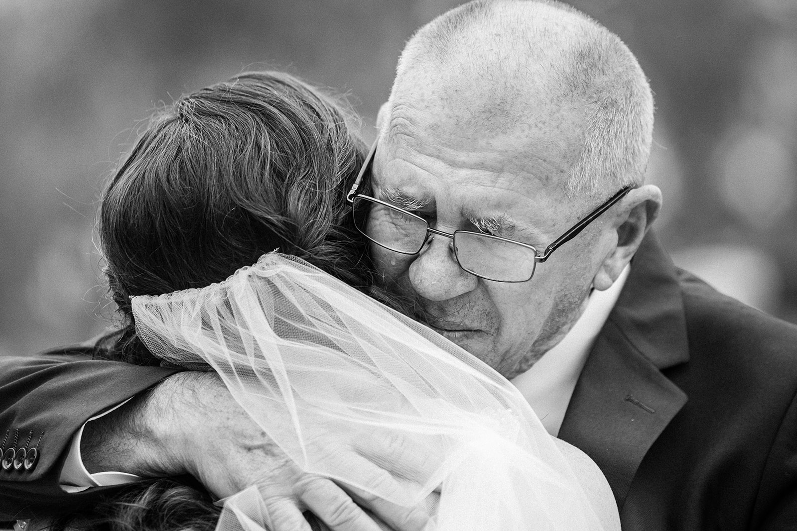 dad hugging bride by Michele Maloney Photography