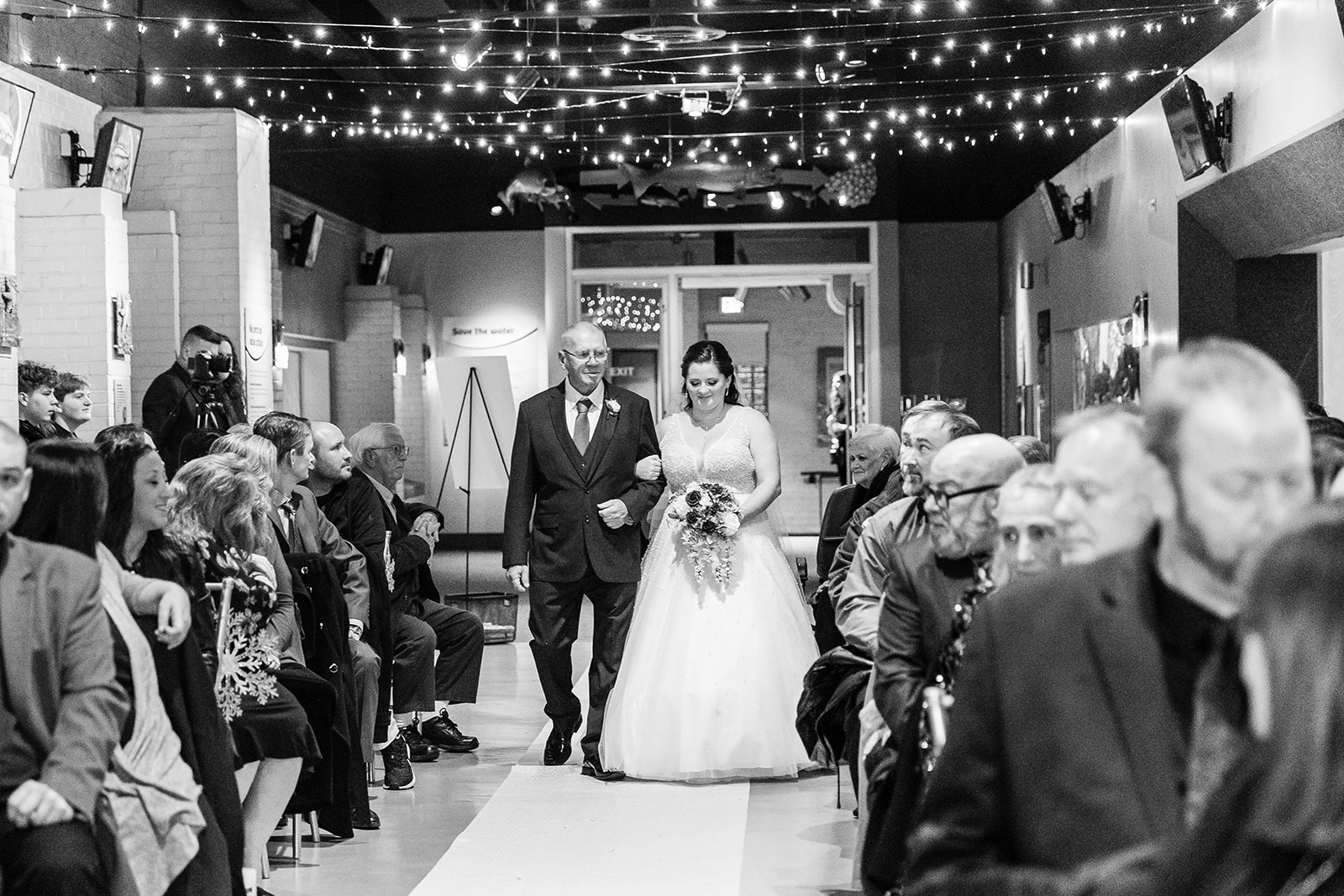 dad walking bride down the aisle at the Aquarium at the Toledo Zoo by Michele Maloney Photography