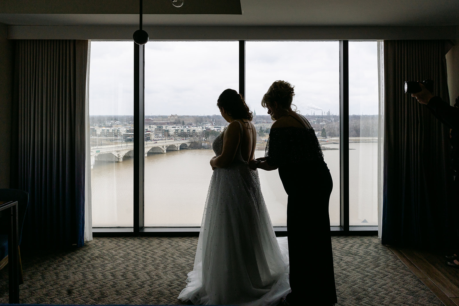 Mother helping Bride into Dress 