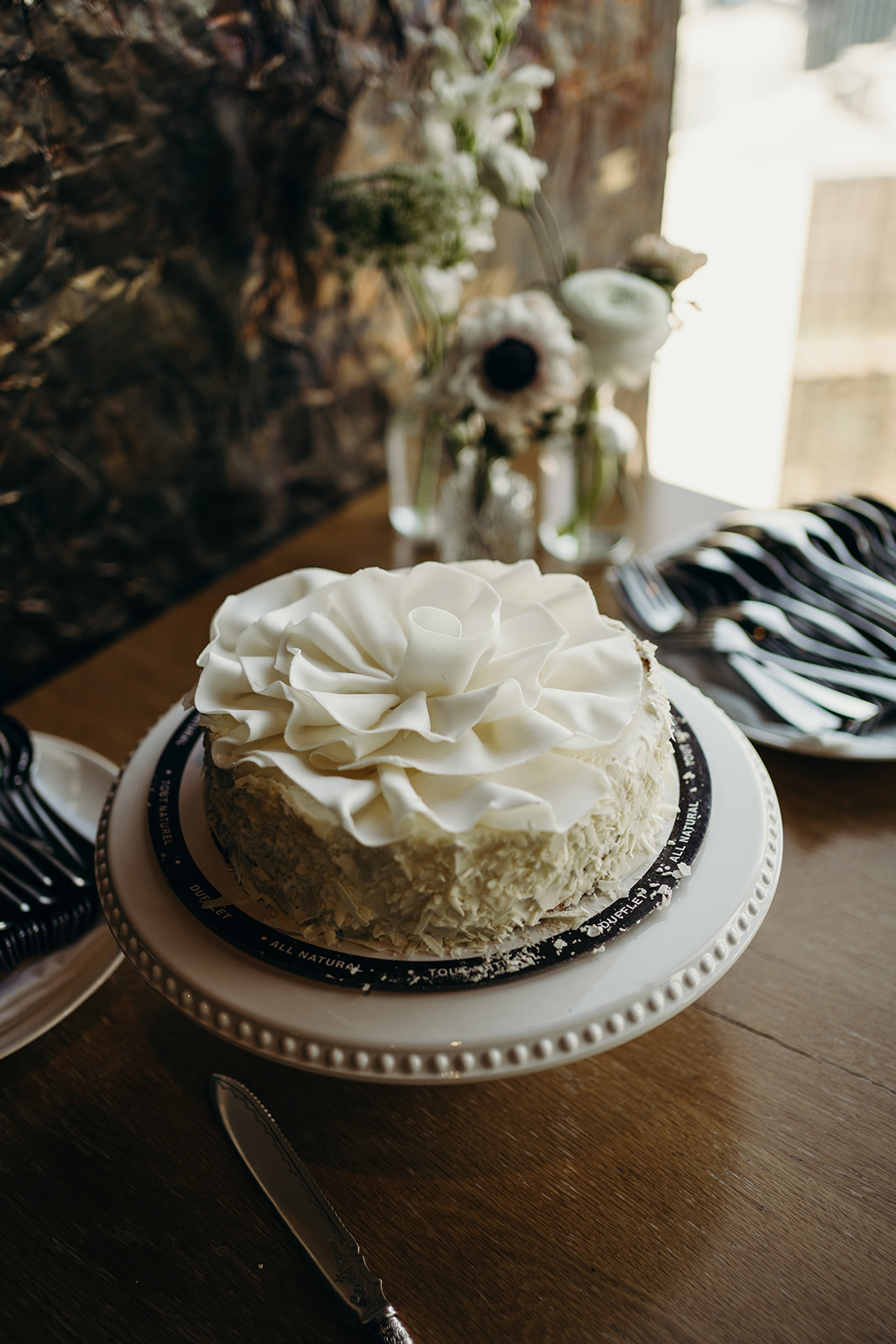 a cake with one white piped-on rose on top.