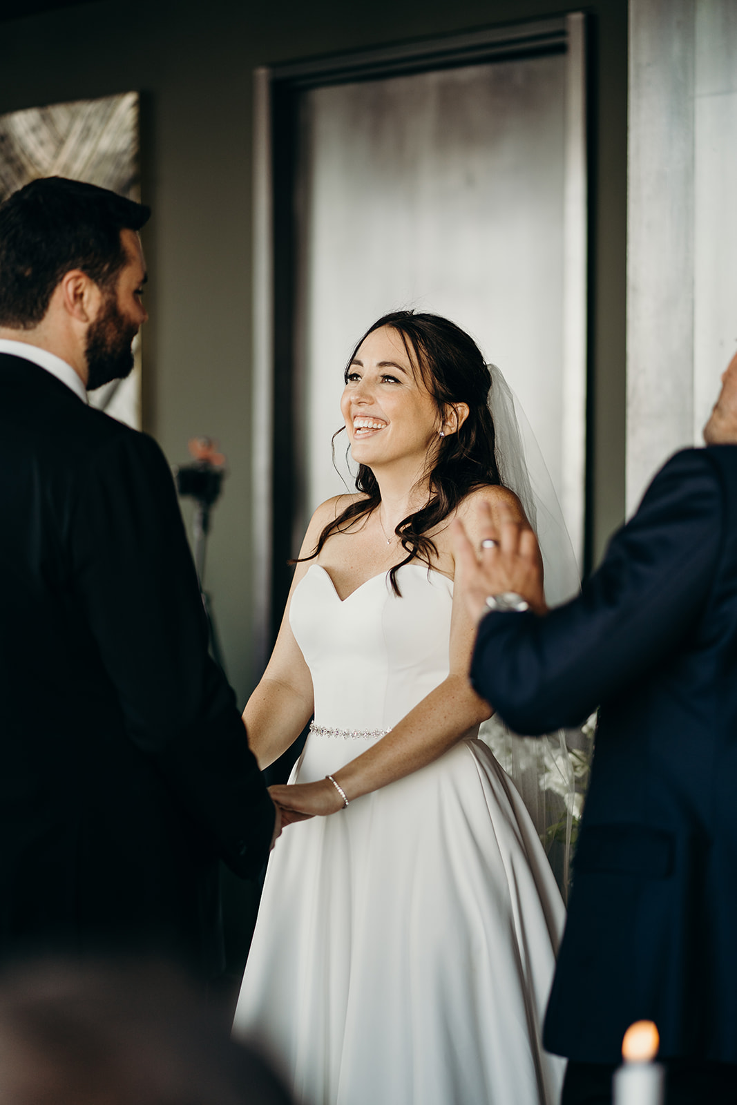 Woman holding hands with man smiling getting married.
