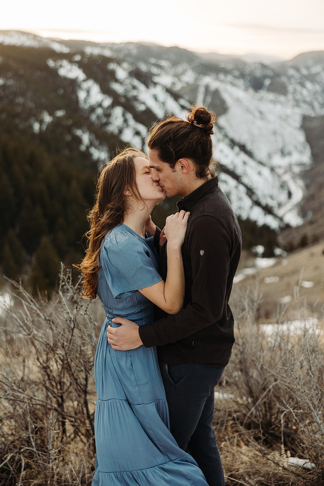 man and woman kissing in the mountains of Colorado during their spring engagement session