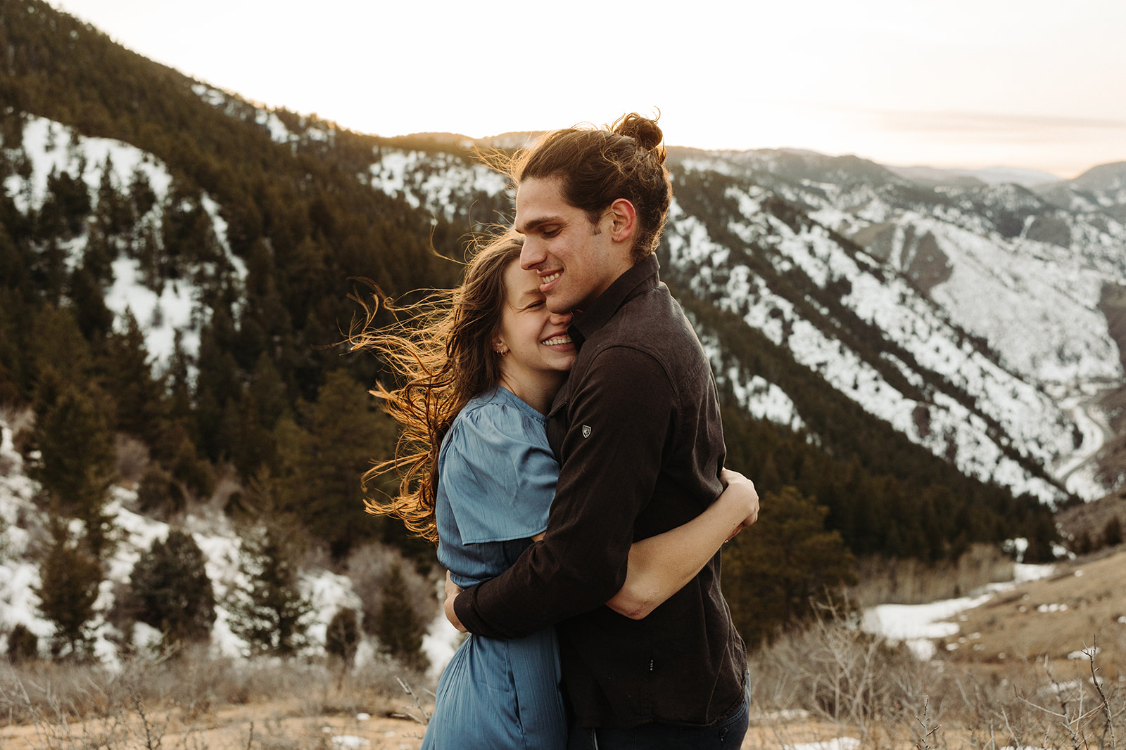 man and woman hugging each other during their spring engagement session