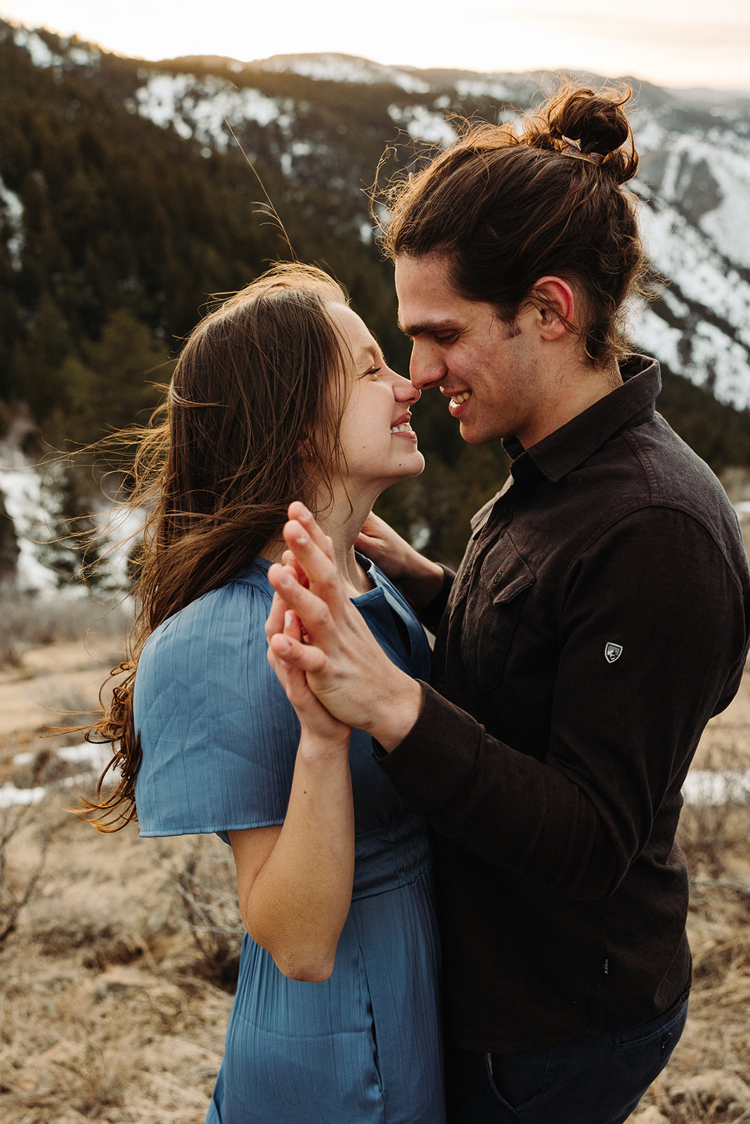 man and woman smiling at each other during their spring engagement session