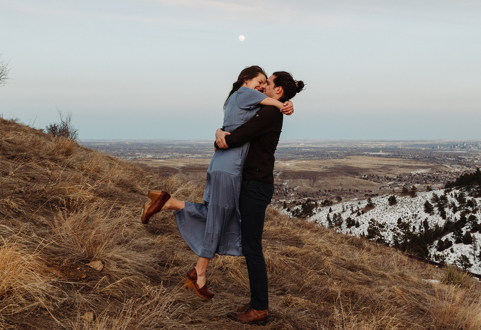 man and woman kissing in the mountains of Colorado during their mountain engagement session
