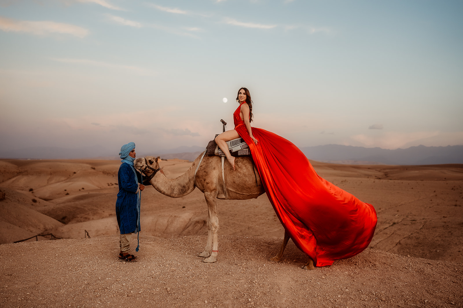 agafay desert in red dress flying