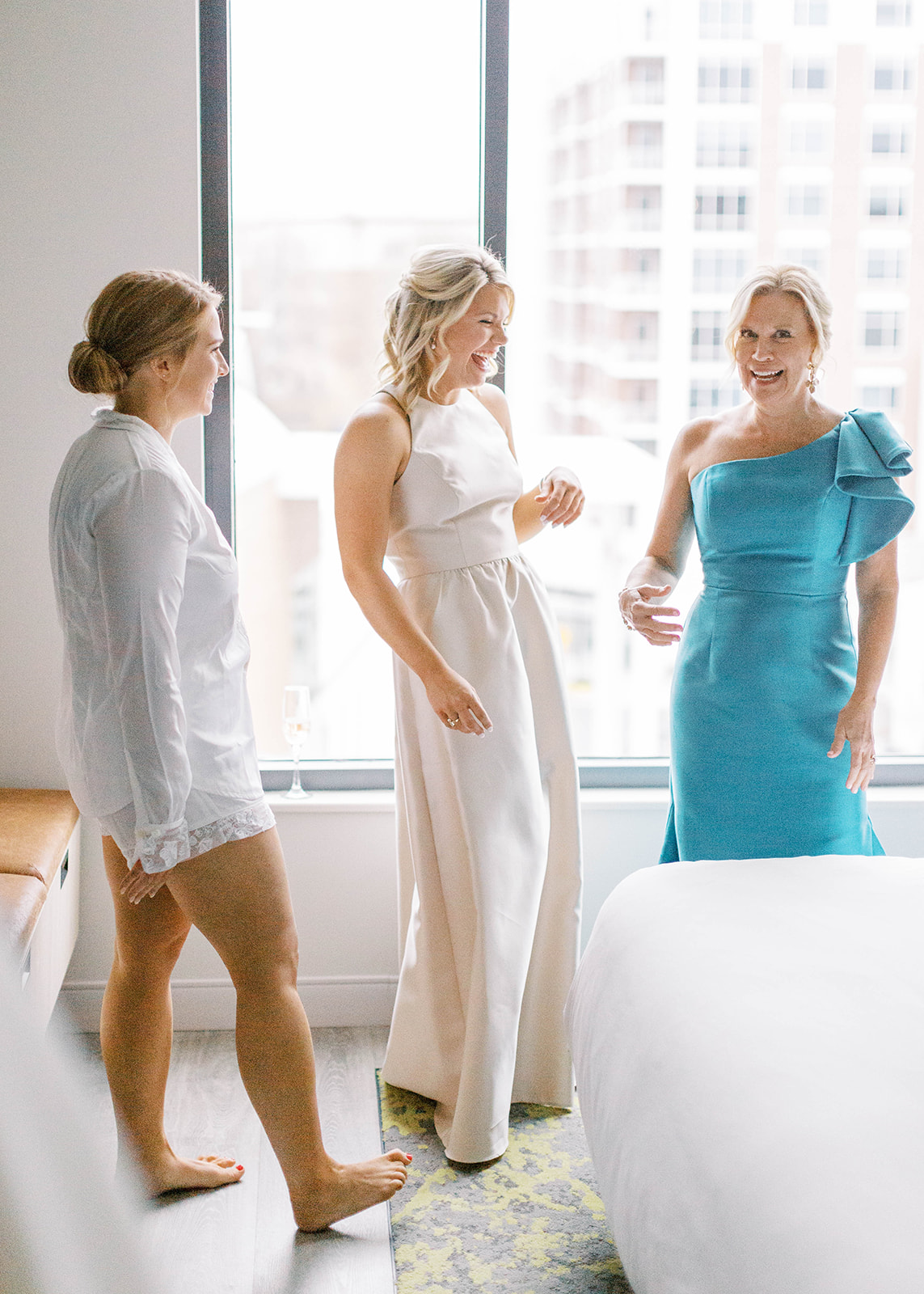 mom, bride, and sister get ready on wedding day