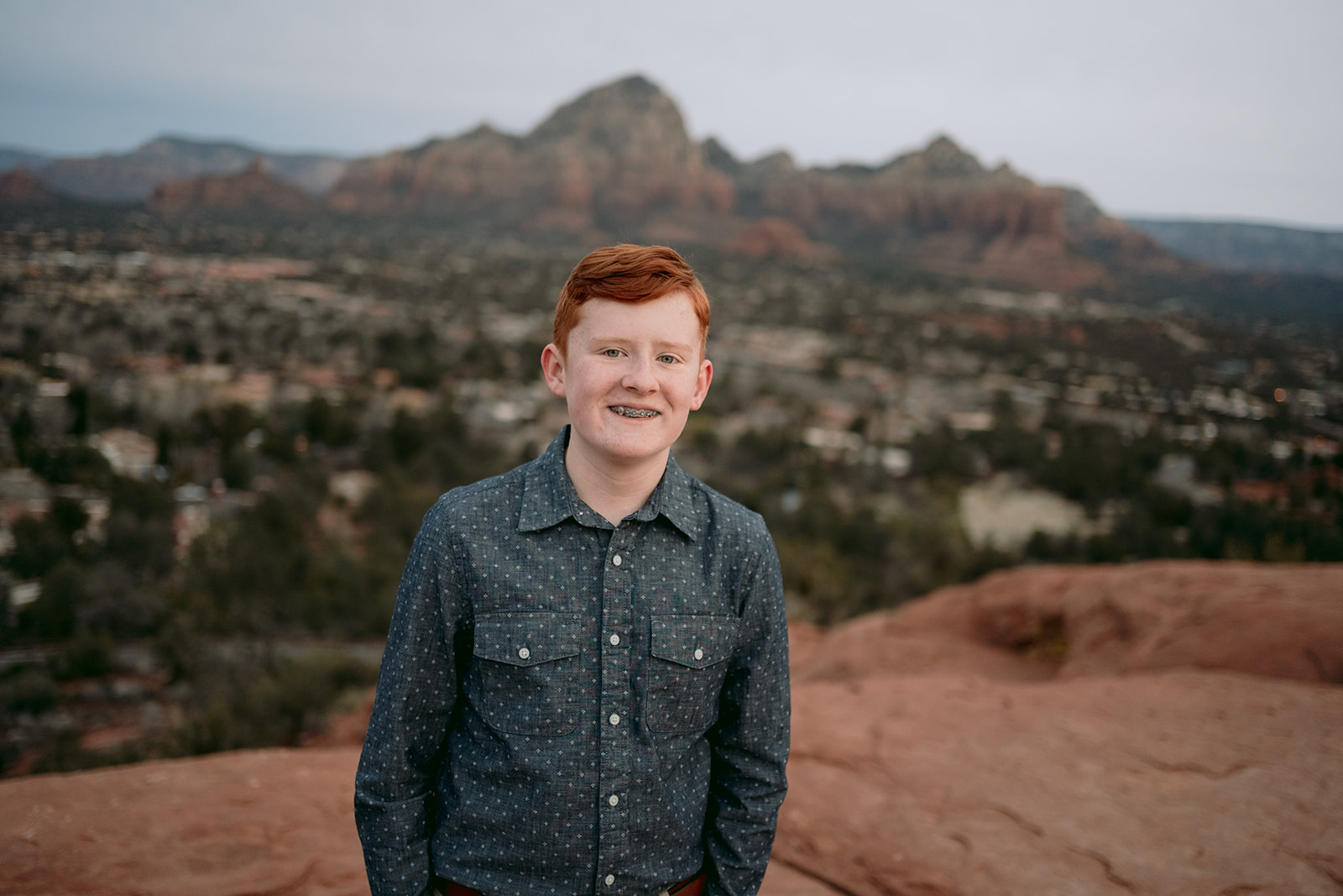 young boy portrait on top of mountain 