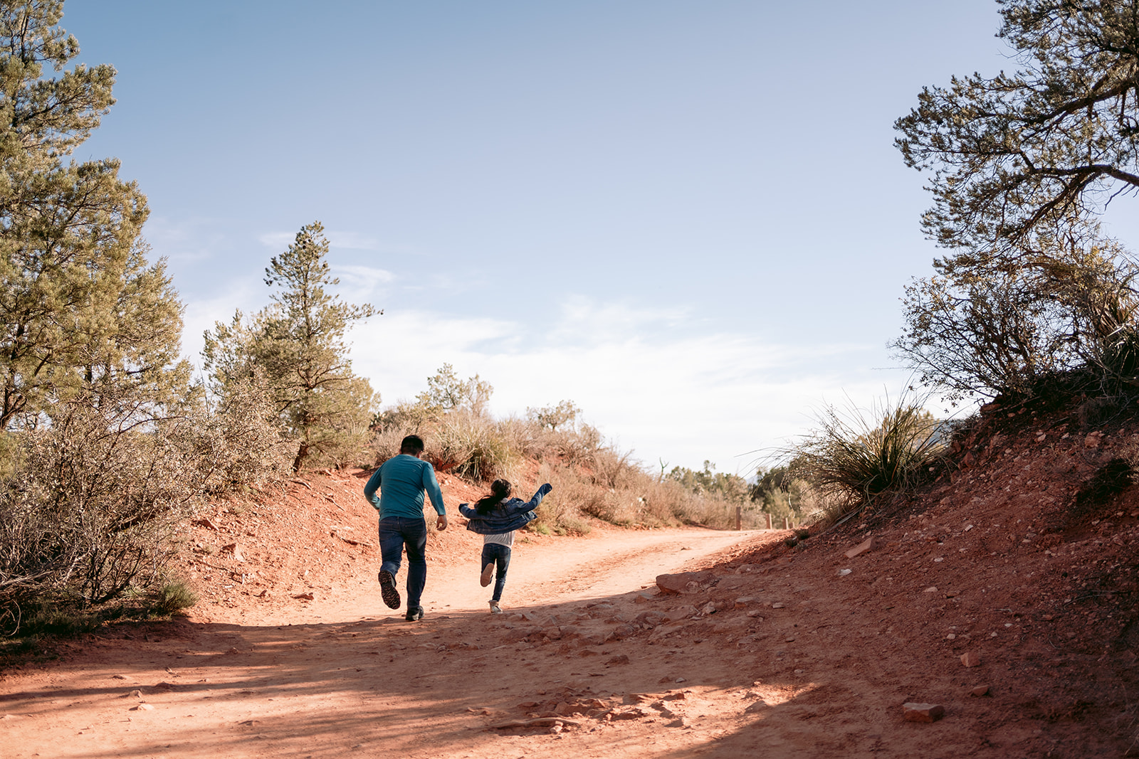 siblings run along a Sedona trail 