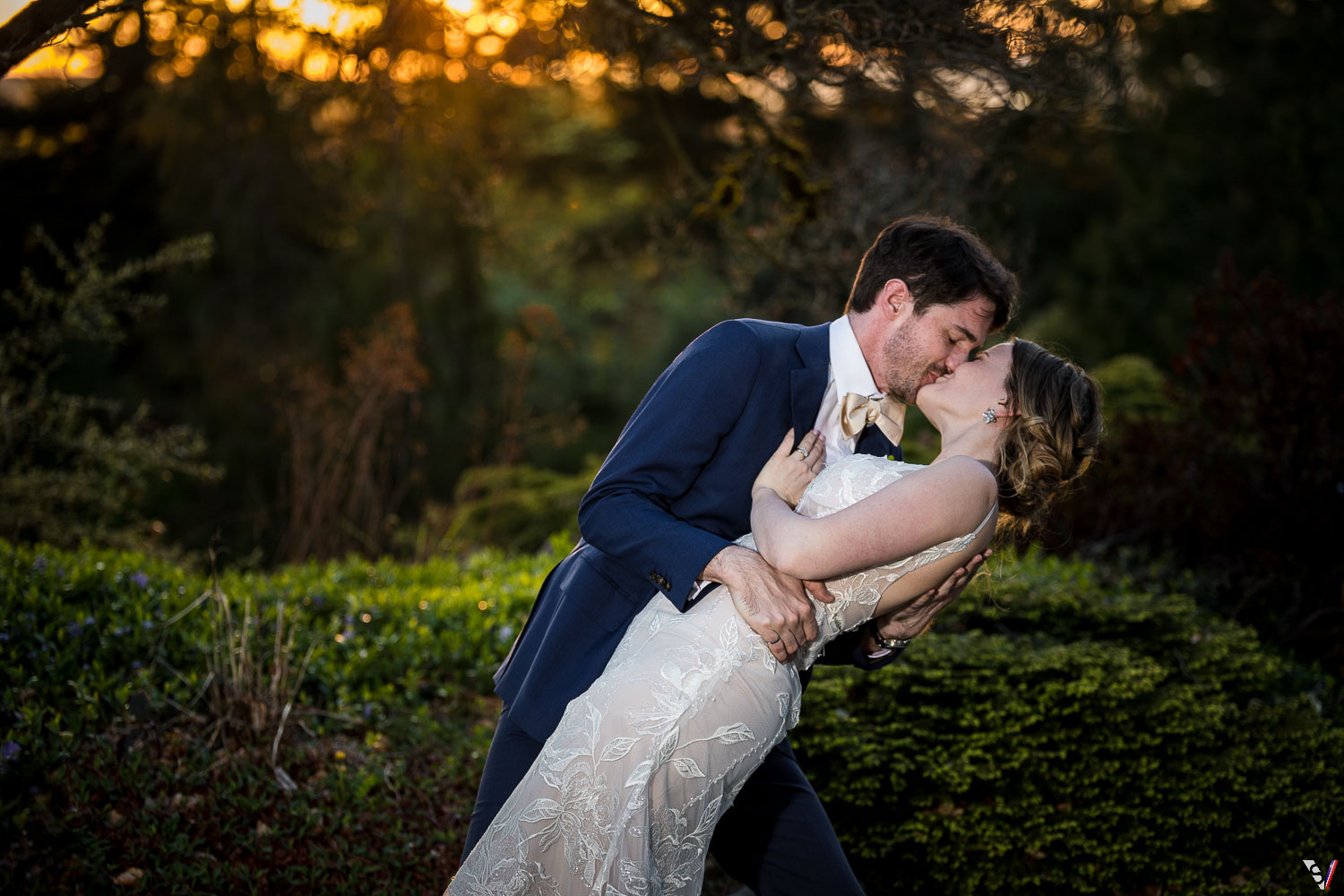 kiss bride and groom sunset photo