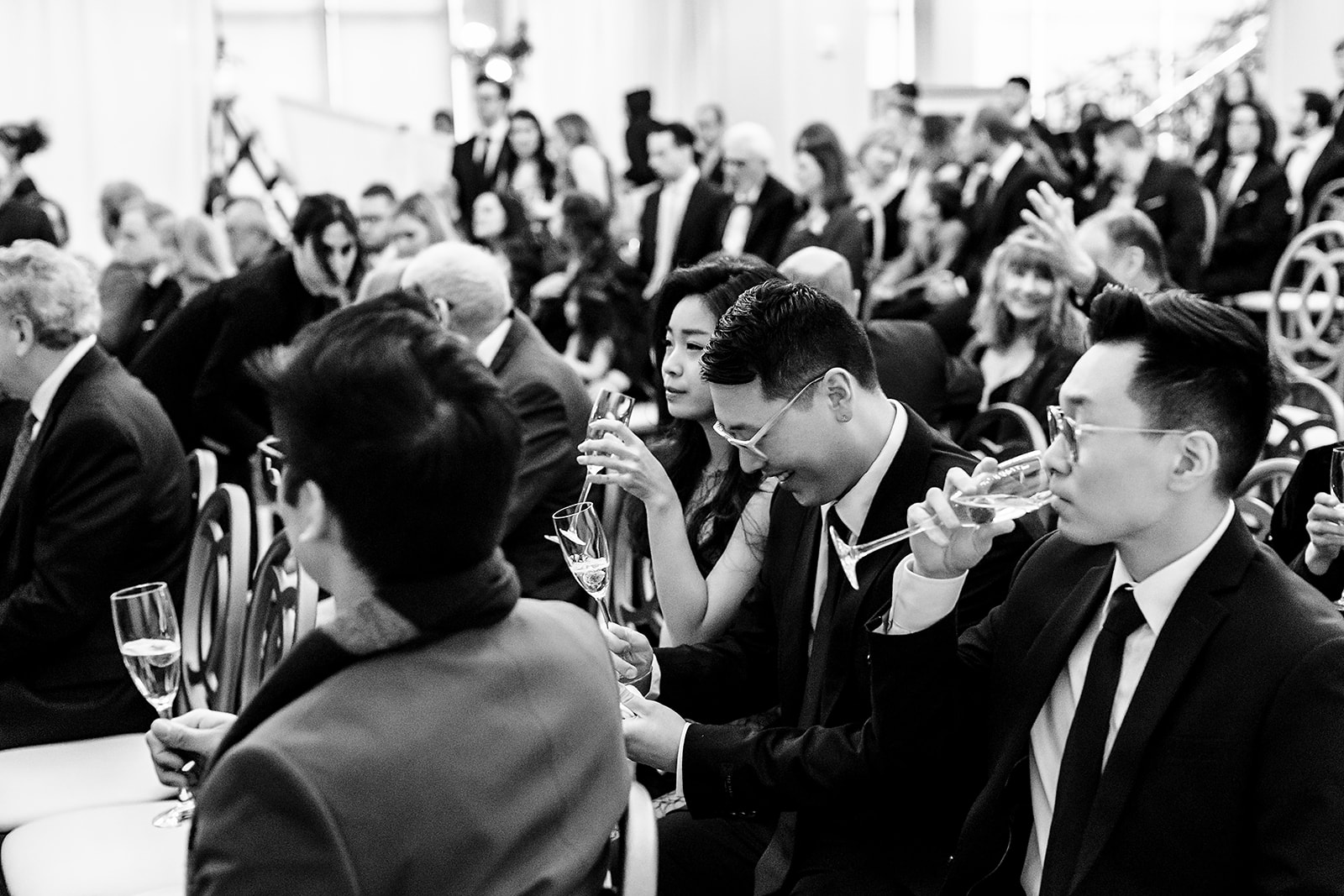 black and white photo of guests waiting for a Cescaphe wedding ceremony 