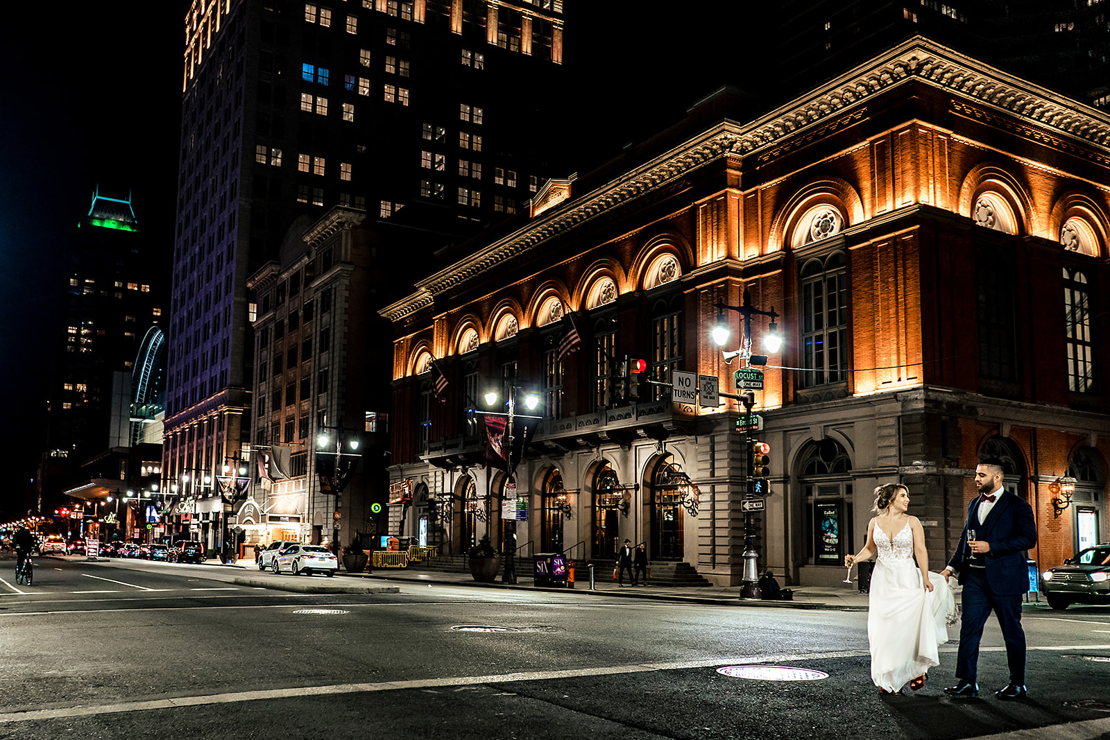 couple walking on broad street by the academy of music