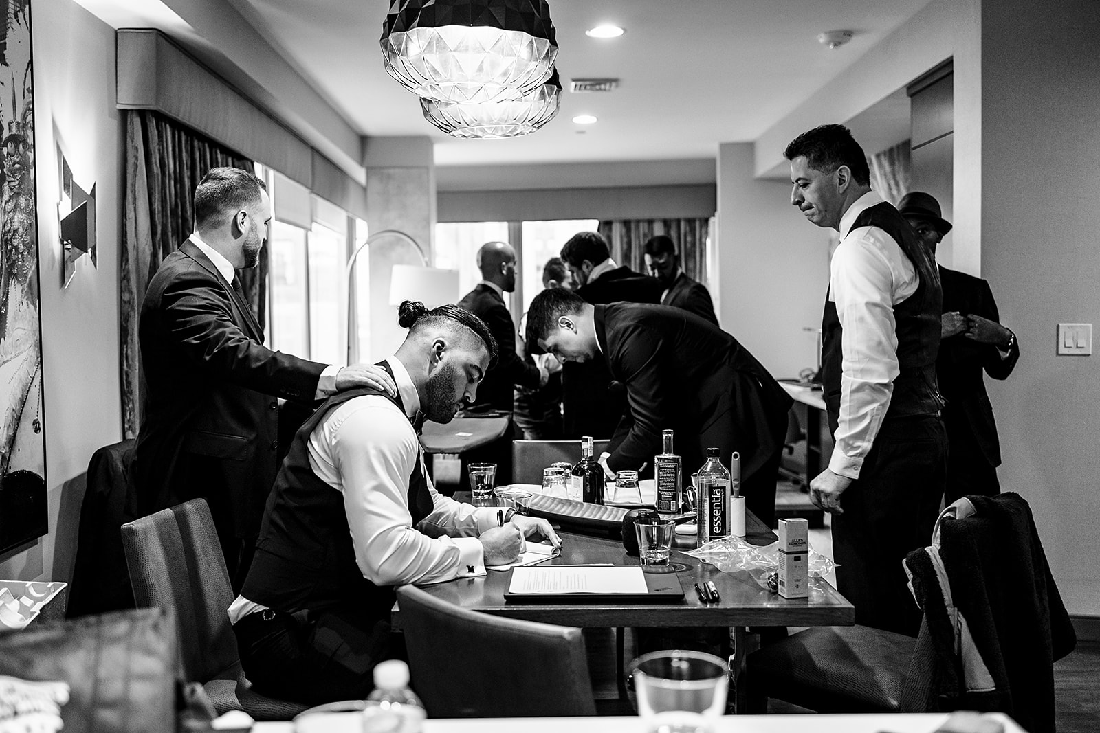 dramatic photo of groom writing a love letter to his future wife on their wedding day.