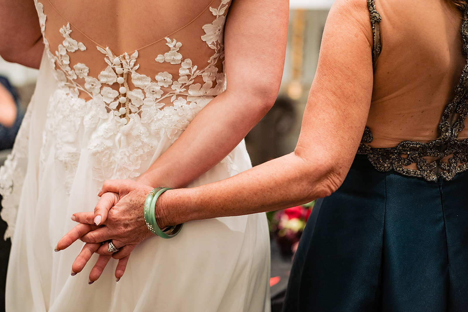 Mom holds daughters hand to calm nerves in the Lucy bridal suite. 