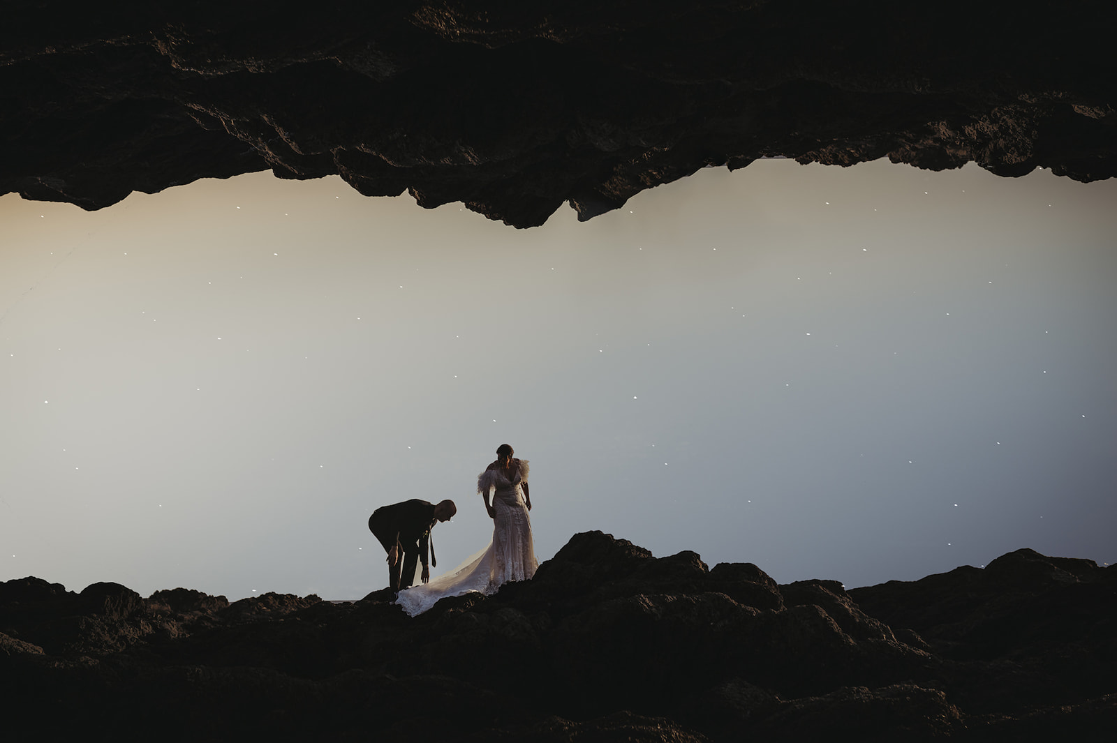 Couple elope on Big Beach in Ucluelet play on the rocks next to Black Rock Resort