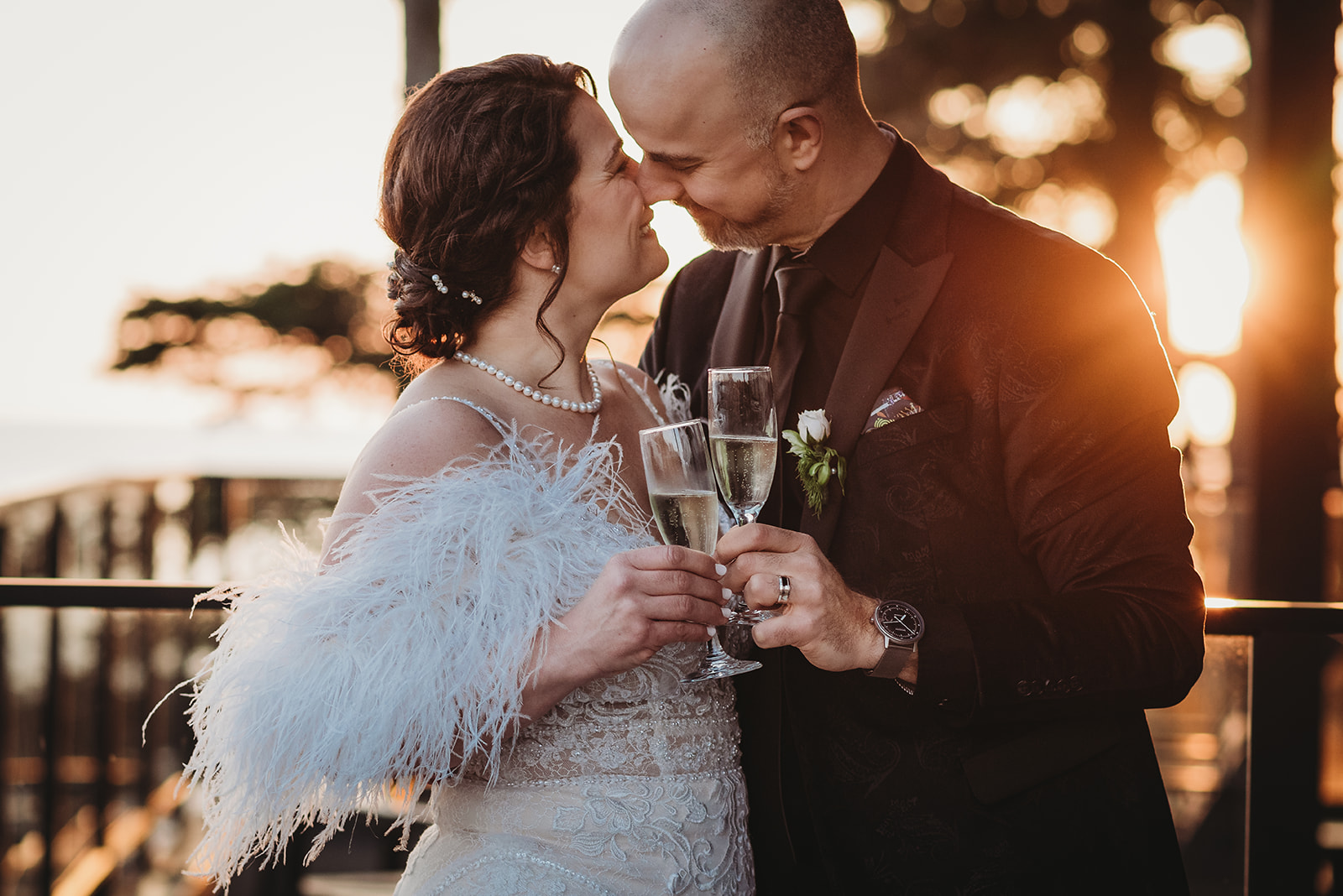 Couple elope in Ucluelet and celebrate with a glass of champagne at sunset on the balcony of Black Rock Resort