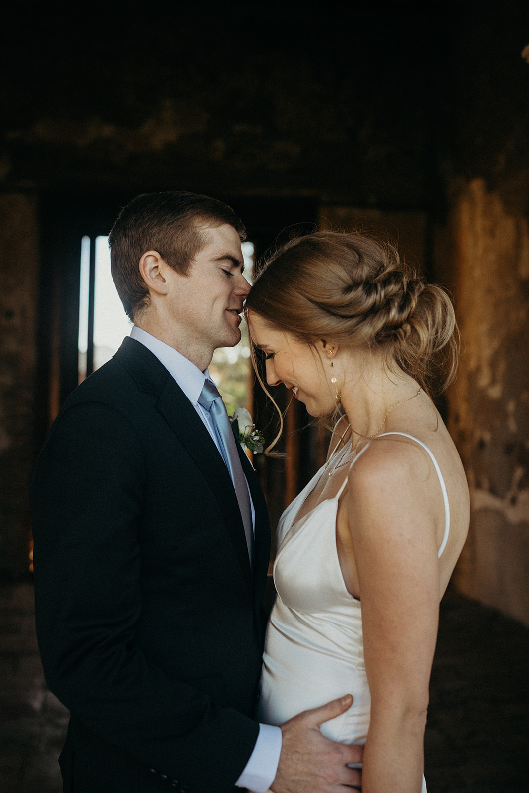 groom kissing bride on forehead